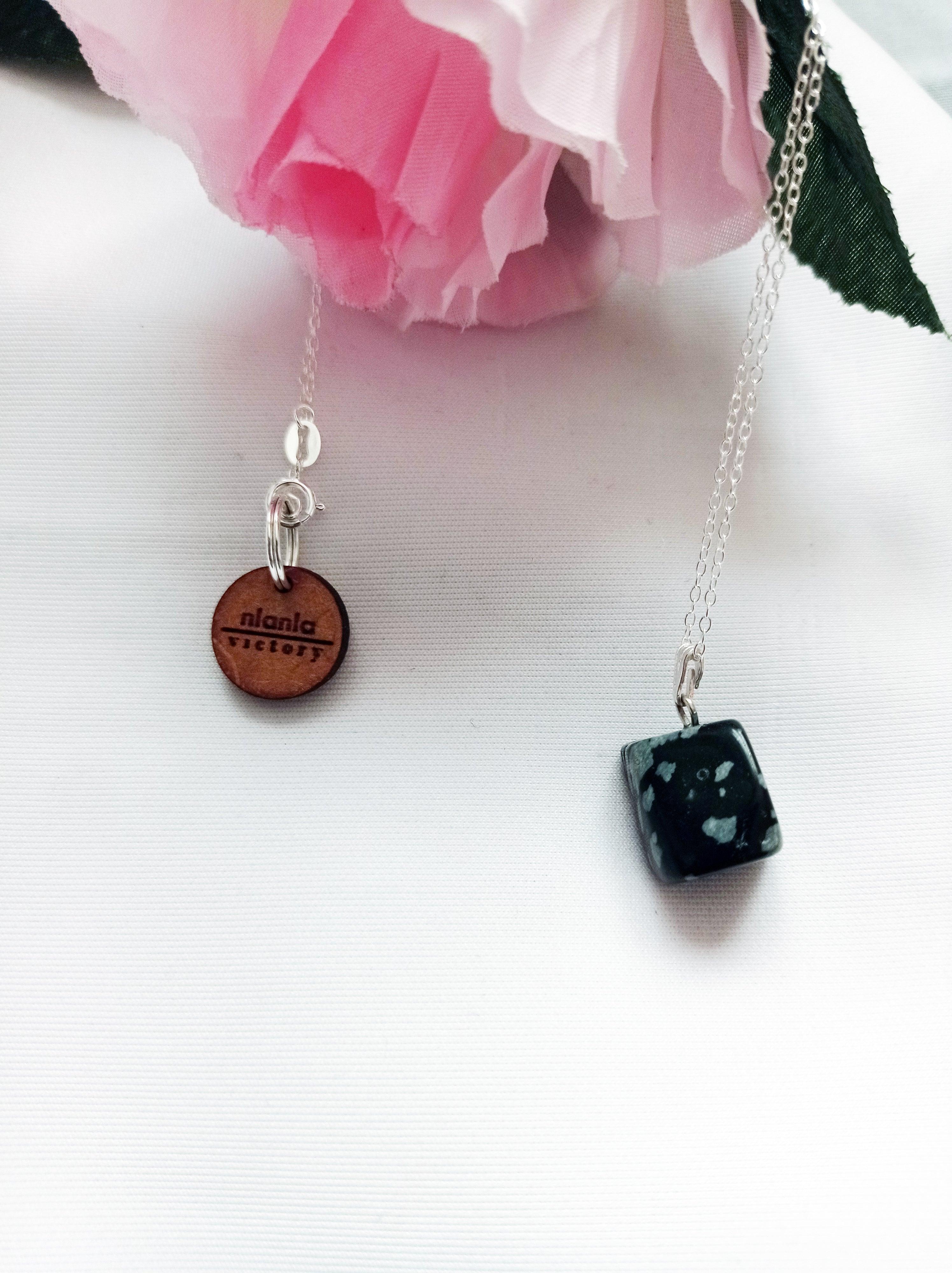 This stunning Snowflake Obsidian Sterling Silver Necklace is perfect for those who love unique and raw gemstones. The beautiful heart pendant is made with high-quality sterling silver and features a mesmerizing Snowflake Obsidian gemstone.

This
