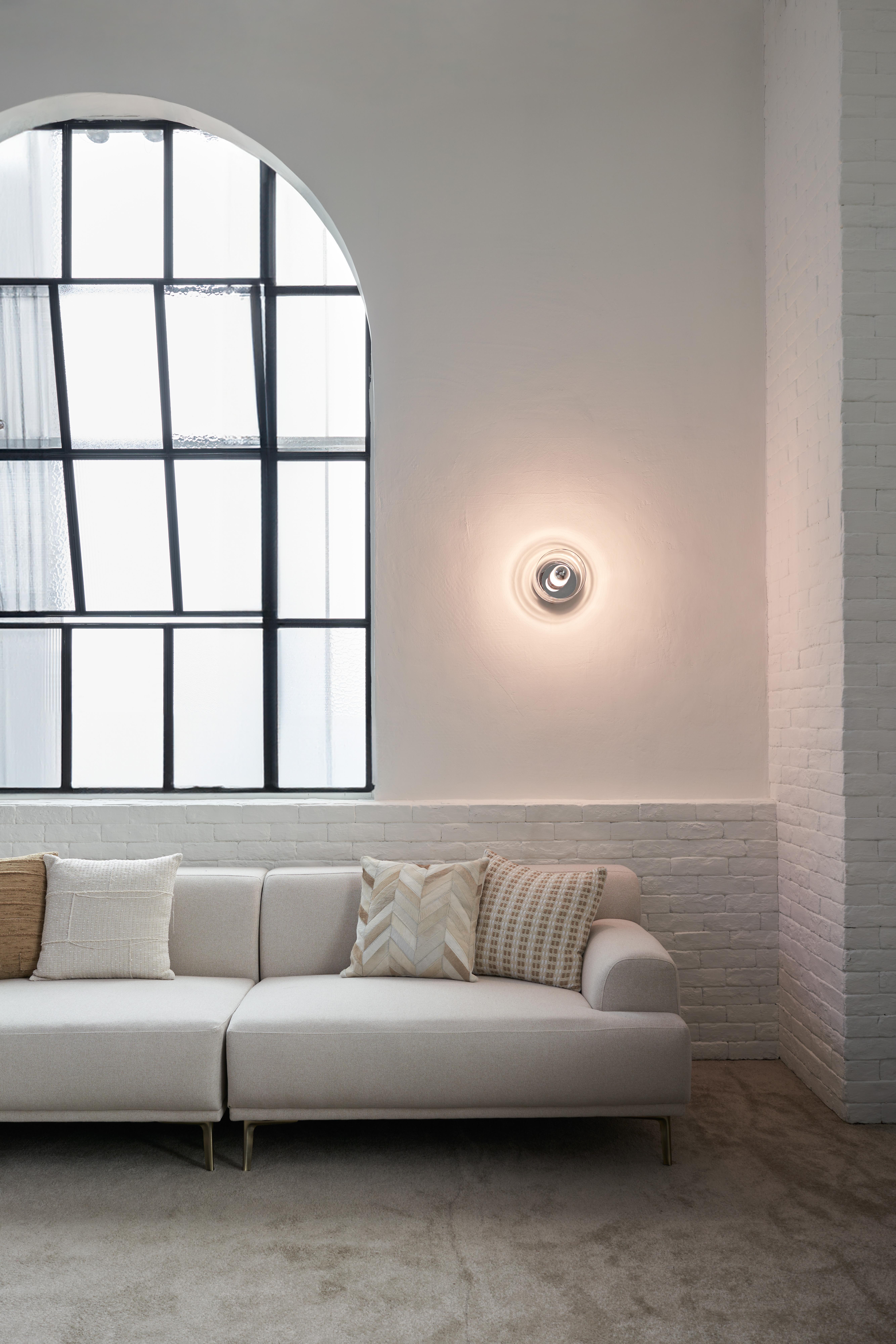 The Snowflake Light derives its name from its elegantly simple silhouette. Its versatile design allows it to function as both a ceiling and wall fixture. The handmade glass shade softly diffuses the light, casting a calming, ambient glow across the