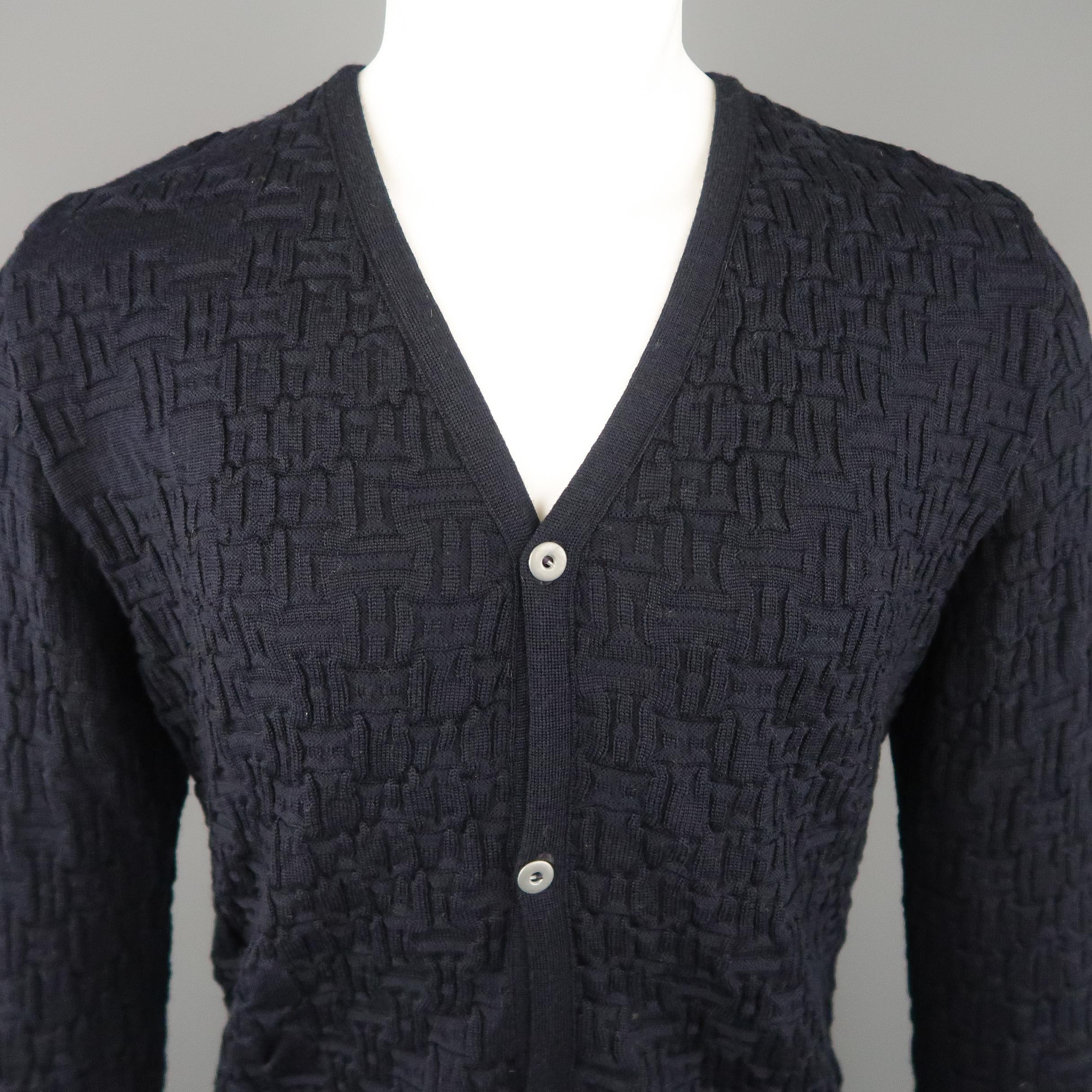 S.N.S. HERNING cardigan sweater comes in a navy textured knit with a V neck, silver tone metal buttons, and ribbed cuffs.  Made in Denmark.
 
Excellent Pre-Owned Condition.
Marked: M
 
Measurements:
 
Shoulder: 18 in.
Chest: 46 in.
Sleeve: 28