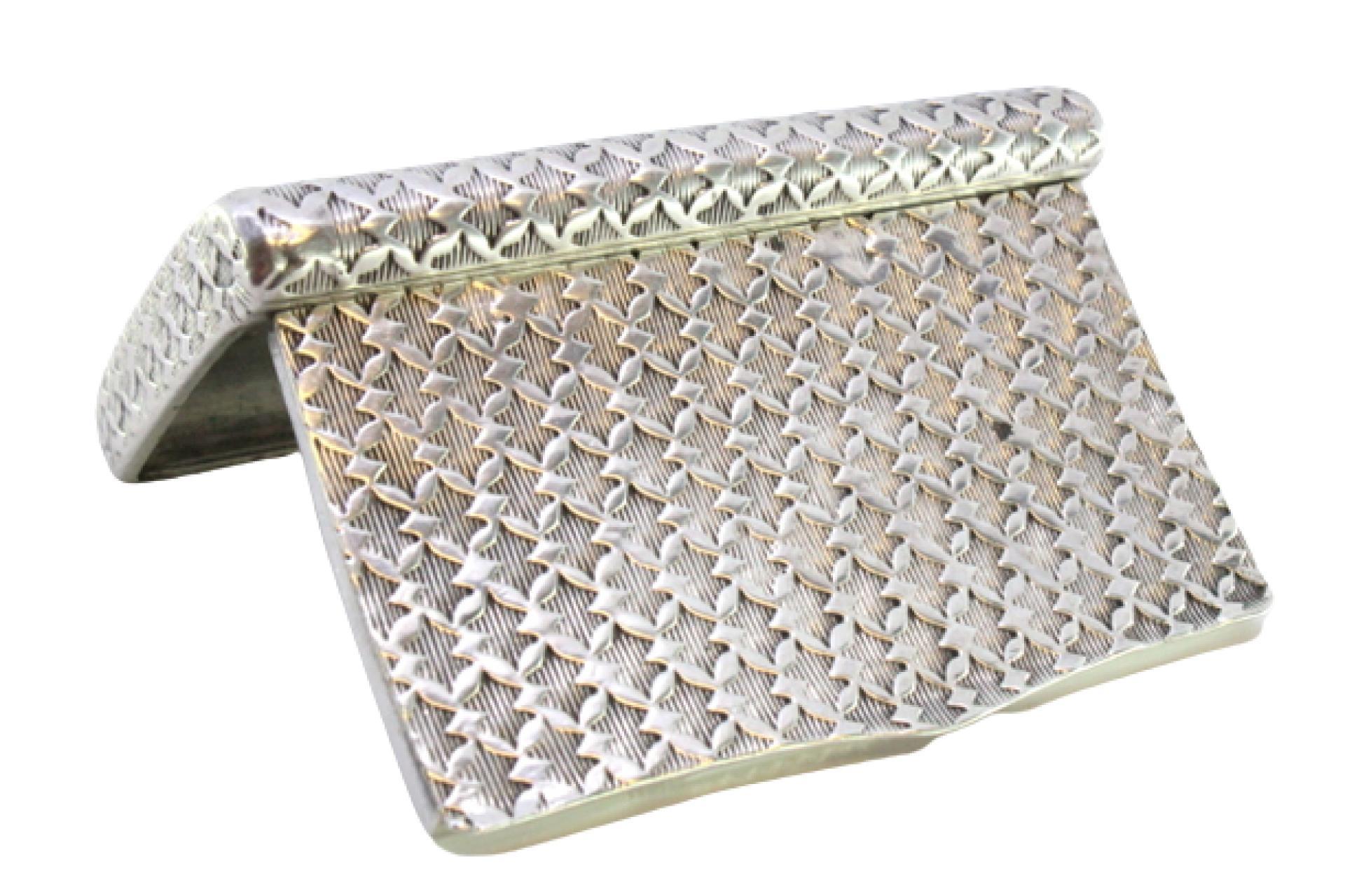 Descrizione: Tabacchiera in argento sbalzato di forma curva e con coperchio a cerniera. Metallo: Argento. Origine: Portoghese. Marchio: Porto Coroa. Peso: 80,64 grammi. Dimensioni: 8cmx5cm. Contenuto: 833/1000. Marchio di controllo: Sì, dal XV