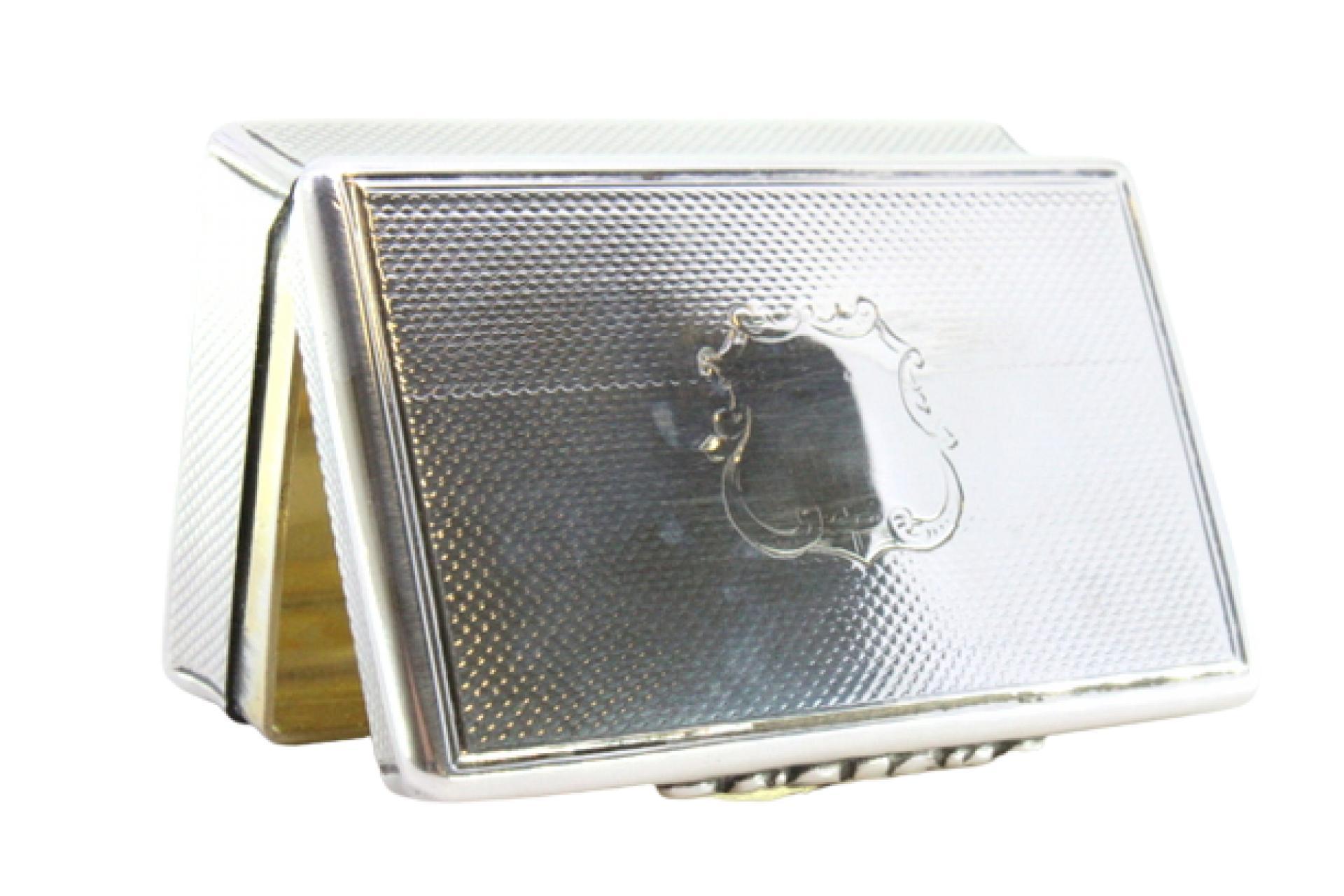 Description: Guilloche silver snuff box with monogrammed card and opening application. Metal: Silver. Origin: English. Brand: Birmingham. Weight: 115.49 grams. Dimensions: 7.8cmx4.8cm. Content: 925/1000. Assay Mark: Yes, 1853 by Edward Smith.