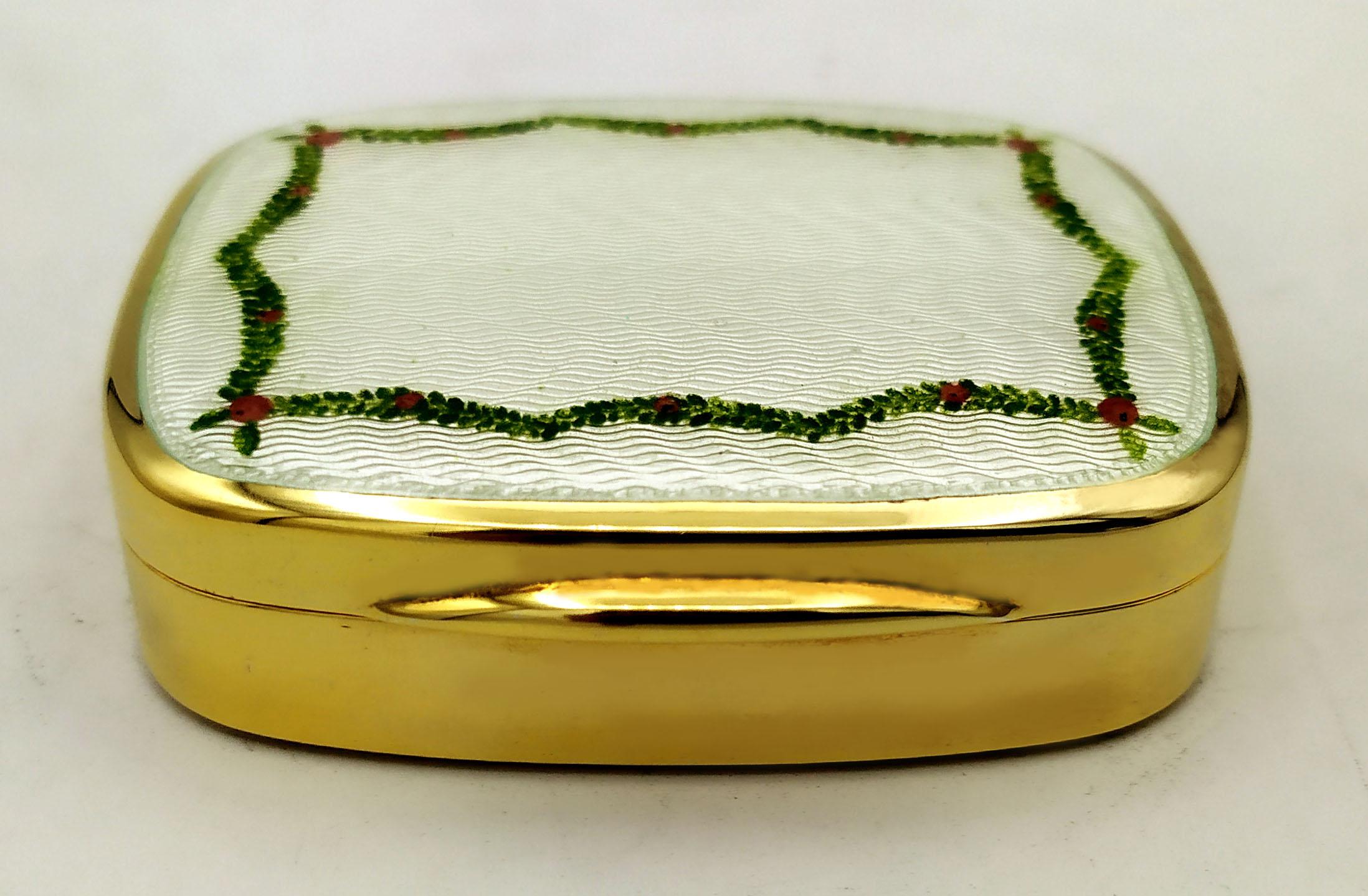 Rounded rectangular table snuffbox in 925/1000 sterling silver gold plated with translucent fired enamels on guillochè and hand-painted miniature of a floral garland. Art Nouveau style early 1900s. Measure cm. 5.8 x 7.2 x 1.8. Weight gr. 139.
