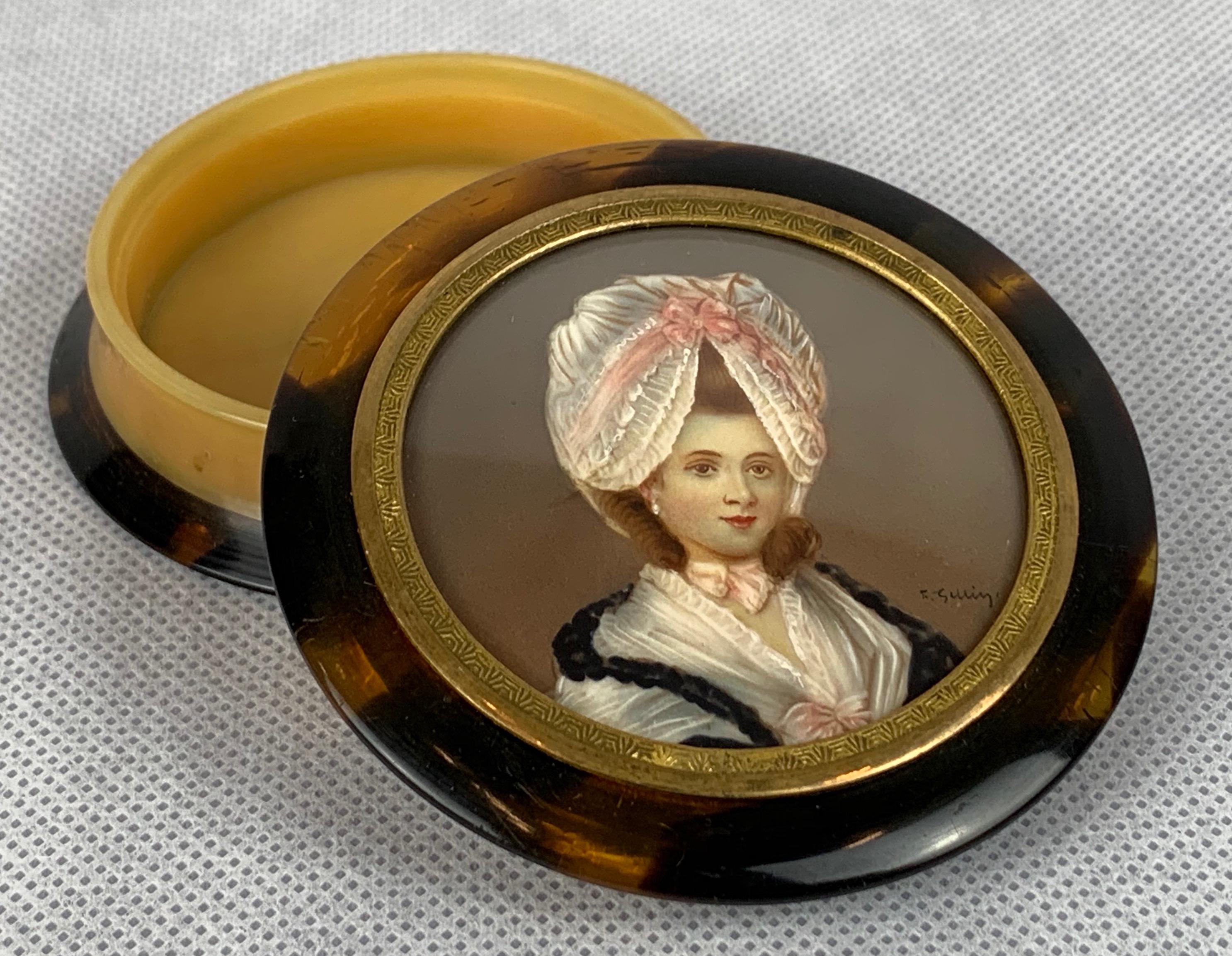 Round nineteenth century snuff box with a beautifully painted portrait of a lady. The case was created with faux tortoise and casein mixed with amber to resemble blond tortoise.
The lid is missing a piece of the top collar that fits into the base