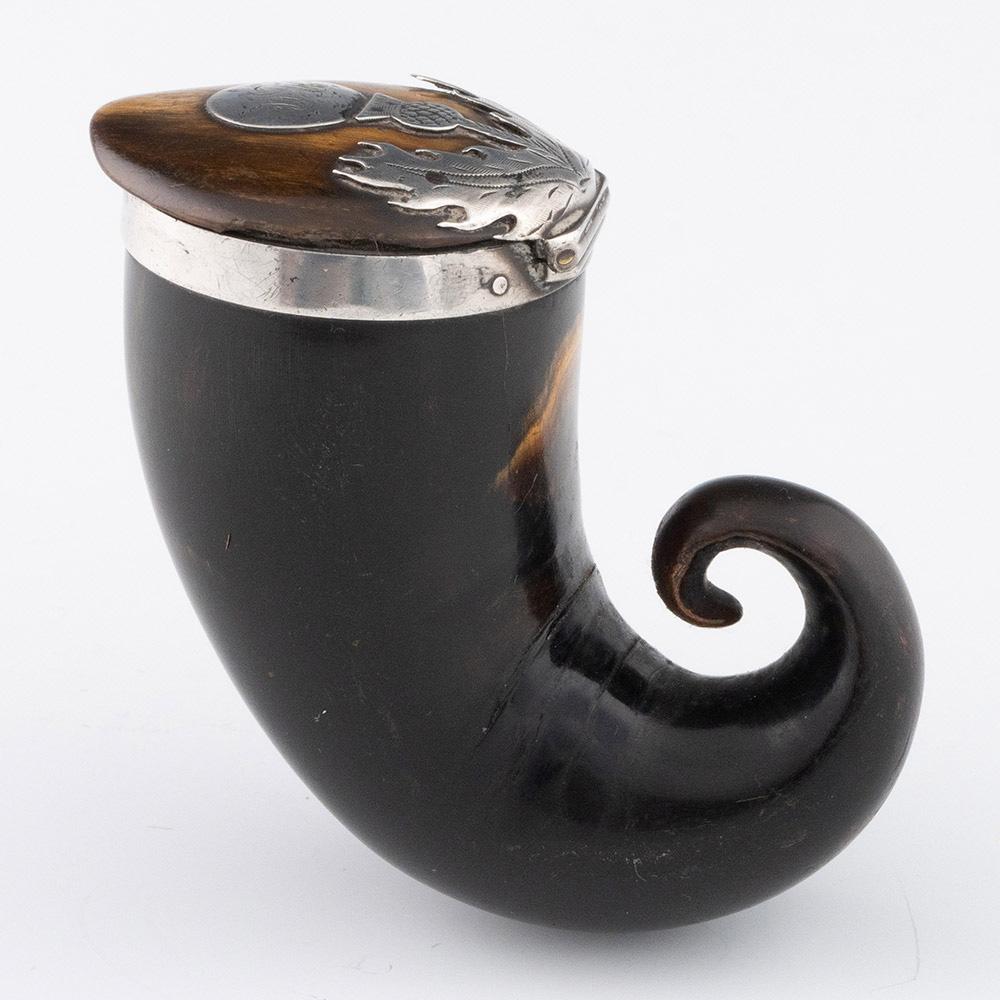 Heading : Rams Horn and silver snuff mull c1820

Period : Regency

Origin : Almost certianly Scottish provincial

Decoration : Horn mull with silver rim and thistle design to cover. Monogrammed.

Size : 8.2cm max lenght, 4cm diameter