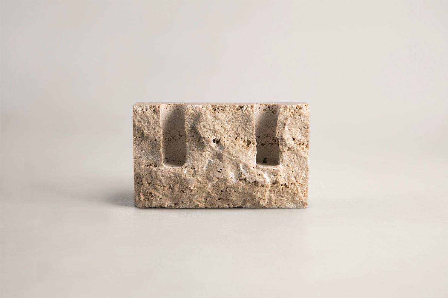 Handcrafted candle holder in Persian travertine with rock face front (hand chipped) and smooth sides. Please note that each stone is unique and reacts differently, therefore important variations in colour, shape and texture occur. 

Snug candle