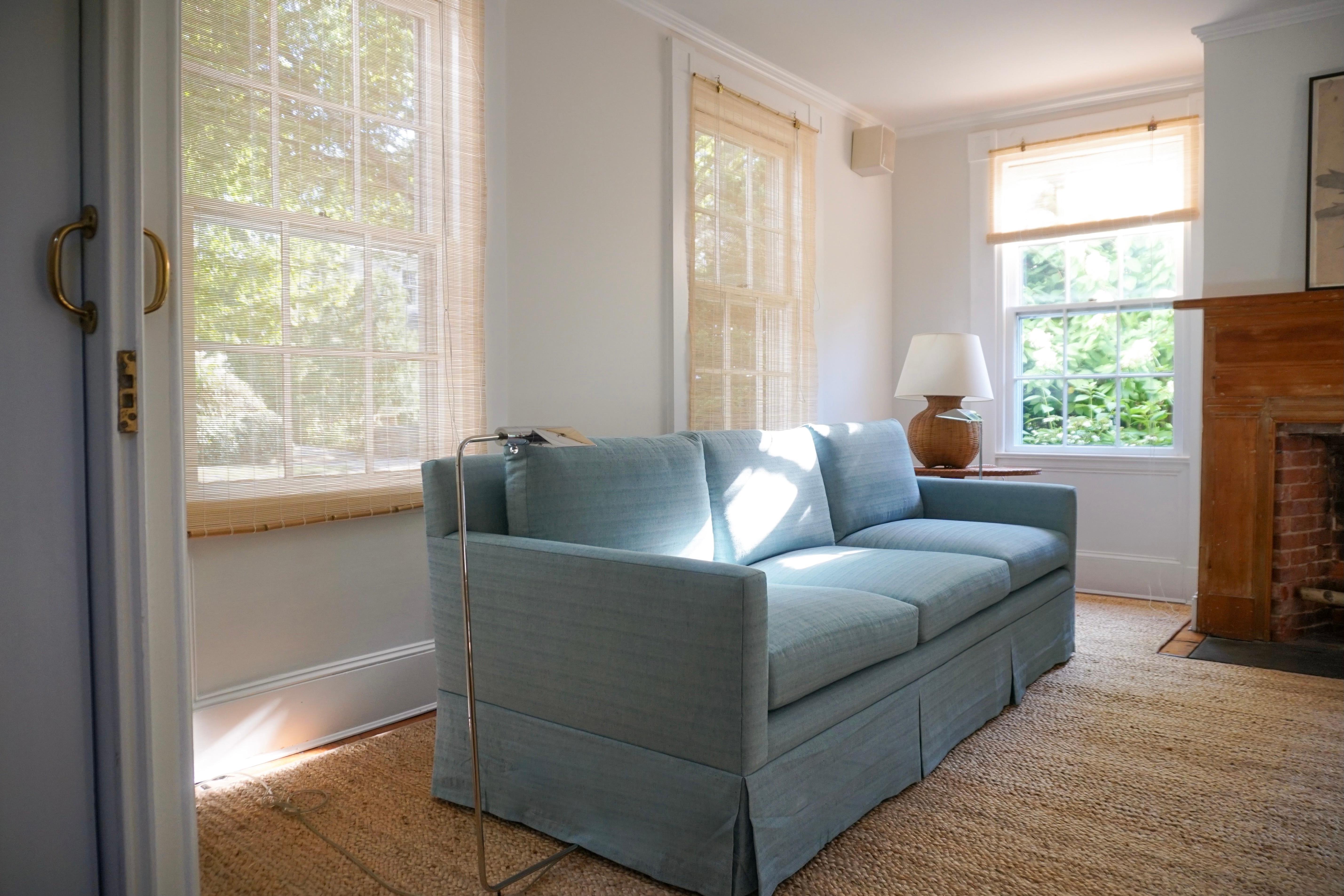 Custom made in NYC, this beautiful three-seater sofa is upholstered in Soane Britain's Old Flax Weave. This piece can blend well with many interior styles. It is both modern and comfortable.