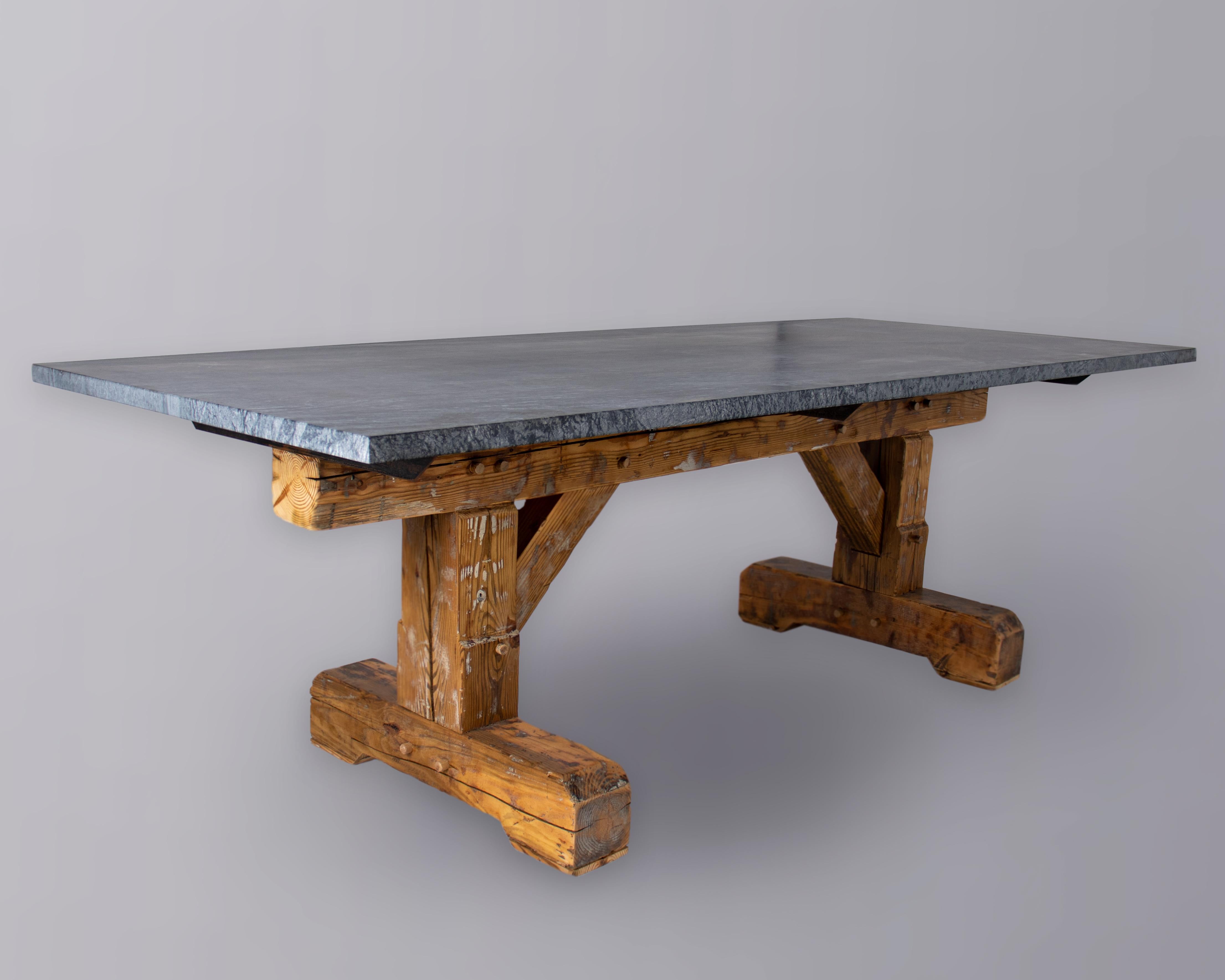 Stope stone leathered top with reclaimed barn beam table base.