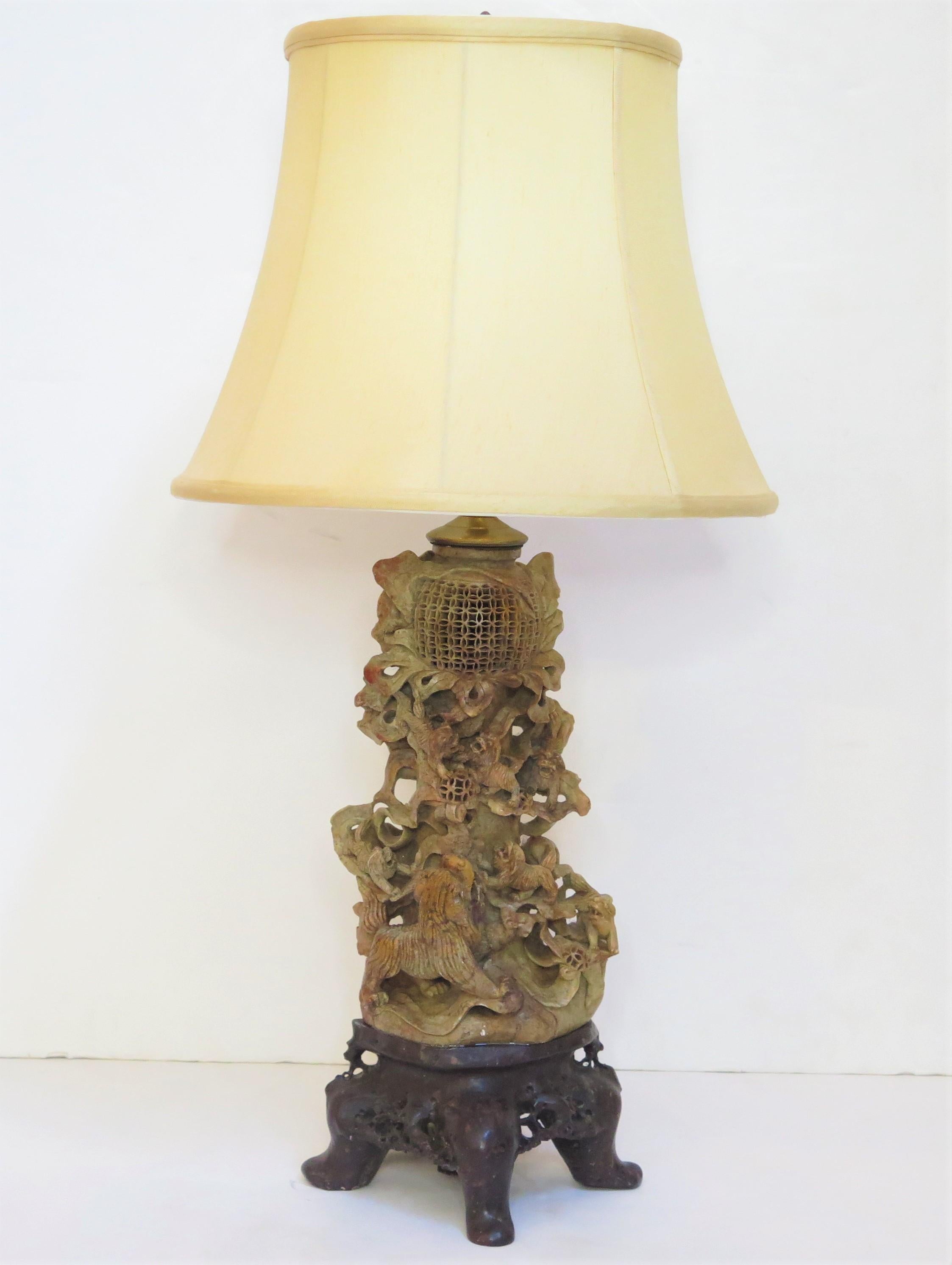 ain intricately carved Chinese soapstone vase as custom table lamp with six (6) foo dogs chasing a ball, brownish-tan coloring, on a darker carved base with four feet, China, 1920s

MEASUREMENTS; 

28