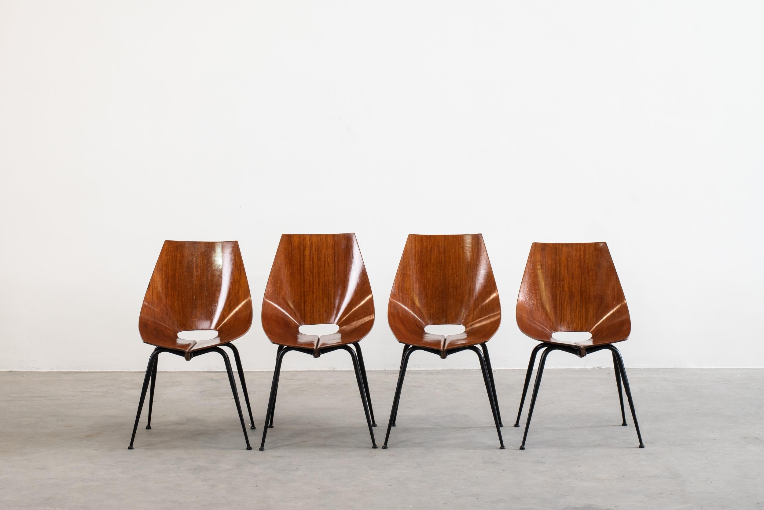 Set of four dining chairs with a frame in black lacquered metal and seat in curved plywood, attributed to Carlo Ratti and produced by Società Compensati Curvati in the 1950s.

In Italy, at the beginning of the XX century, industries of curved solid