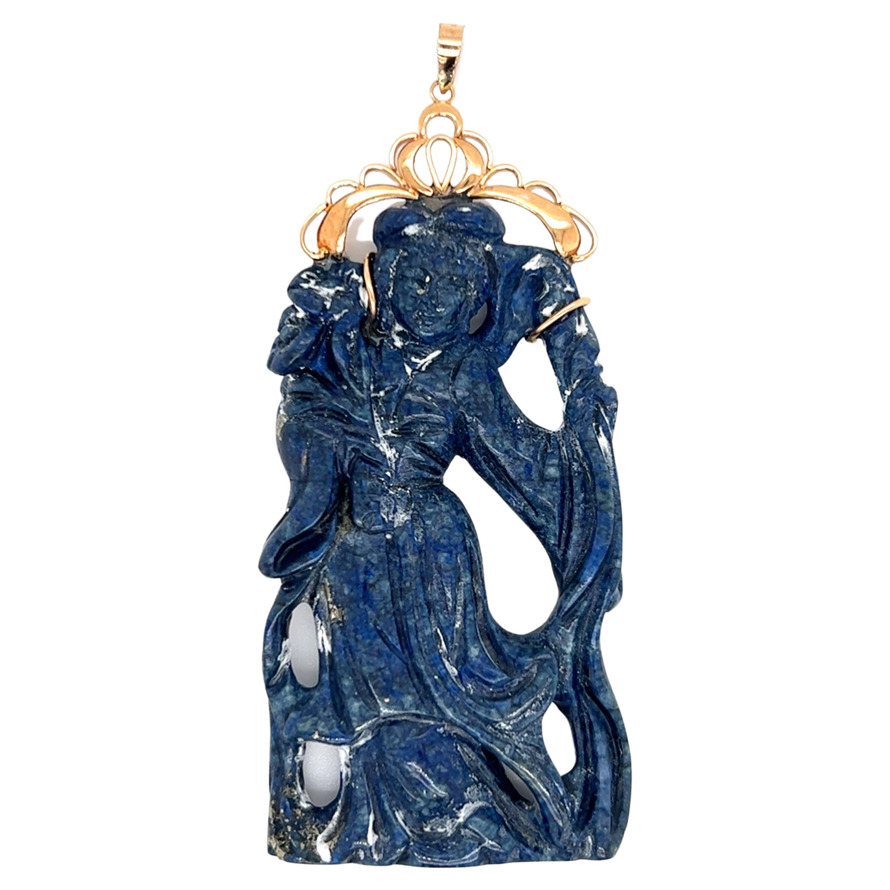 One sodalite pendant is carved in a woman design and is suspended from a 14-karat yellow gold bail.  The pendant measures 3 inches long and 1.25 inches wide.  Circa 1970.