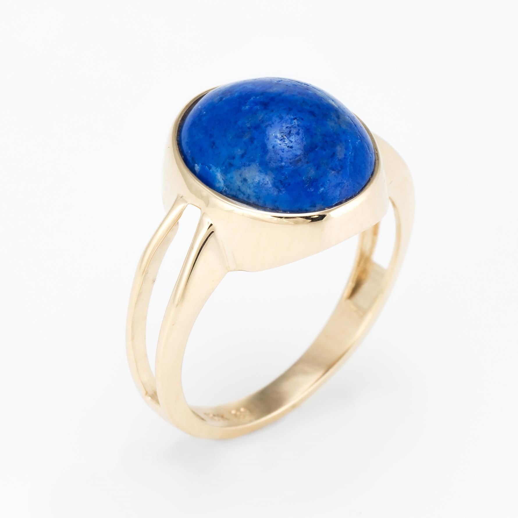 Elegant vintage cocktail ring (circa 1960s to 1970s), crafted in 10 karat yellow gold. 

Centrally mounted cabochon cut sodalite measures 12mm x 10mm (estimated at 5 carats). Note: natural fissures to the stone.   

The ring is in very good