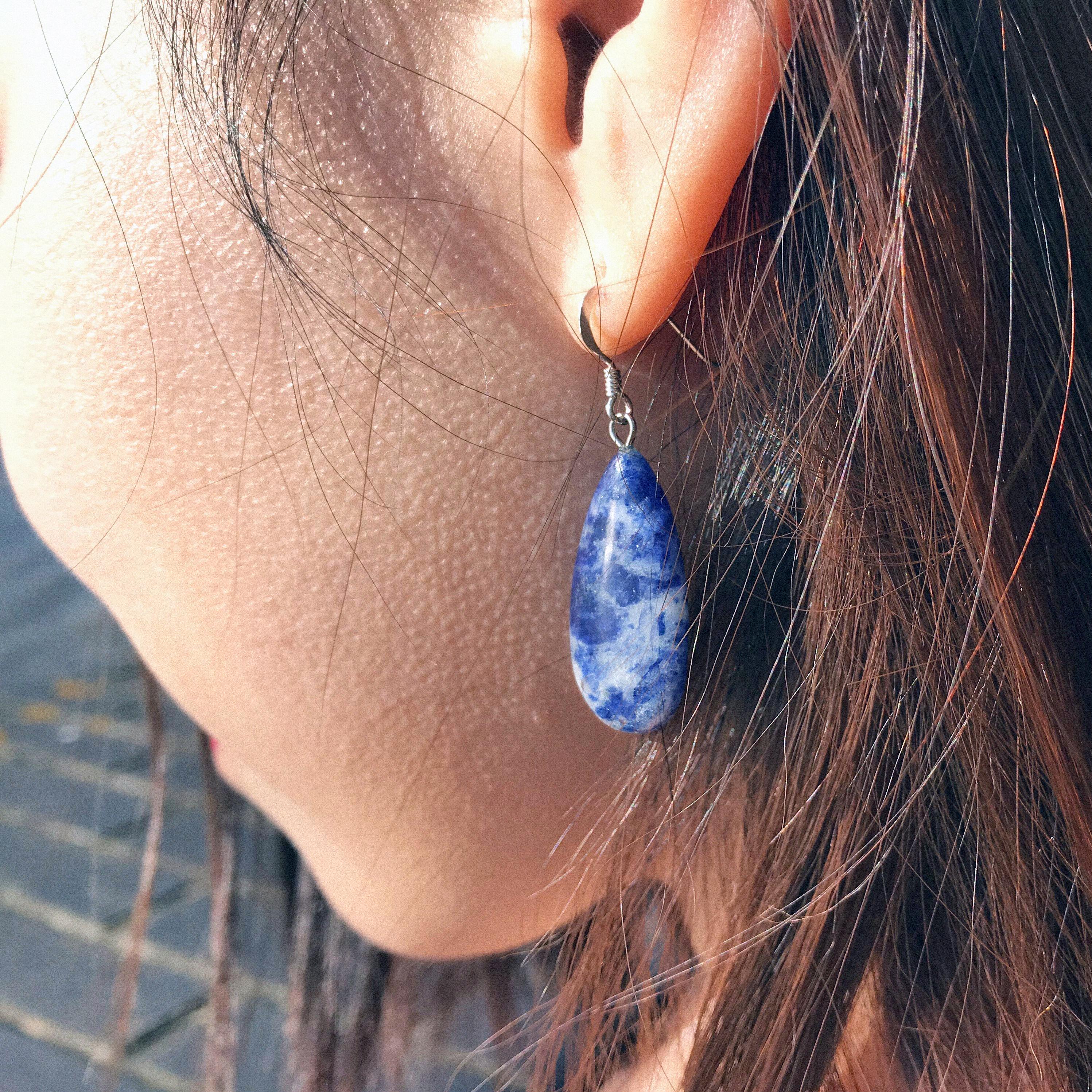 Handcrafted from the mesmerizing Sodalite gemstone, these elegant teardrop earrings are designed to make a statement. The combination of greys and blues in Sodalite create a mysterious and stunning look, perfect for both daytime and evening