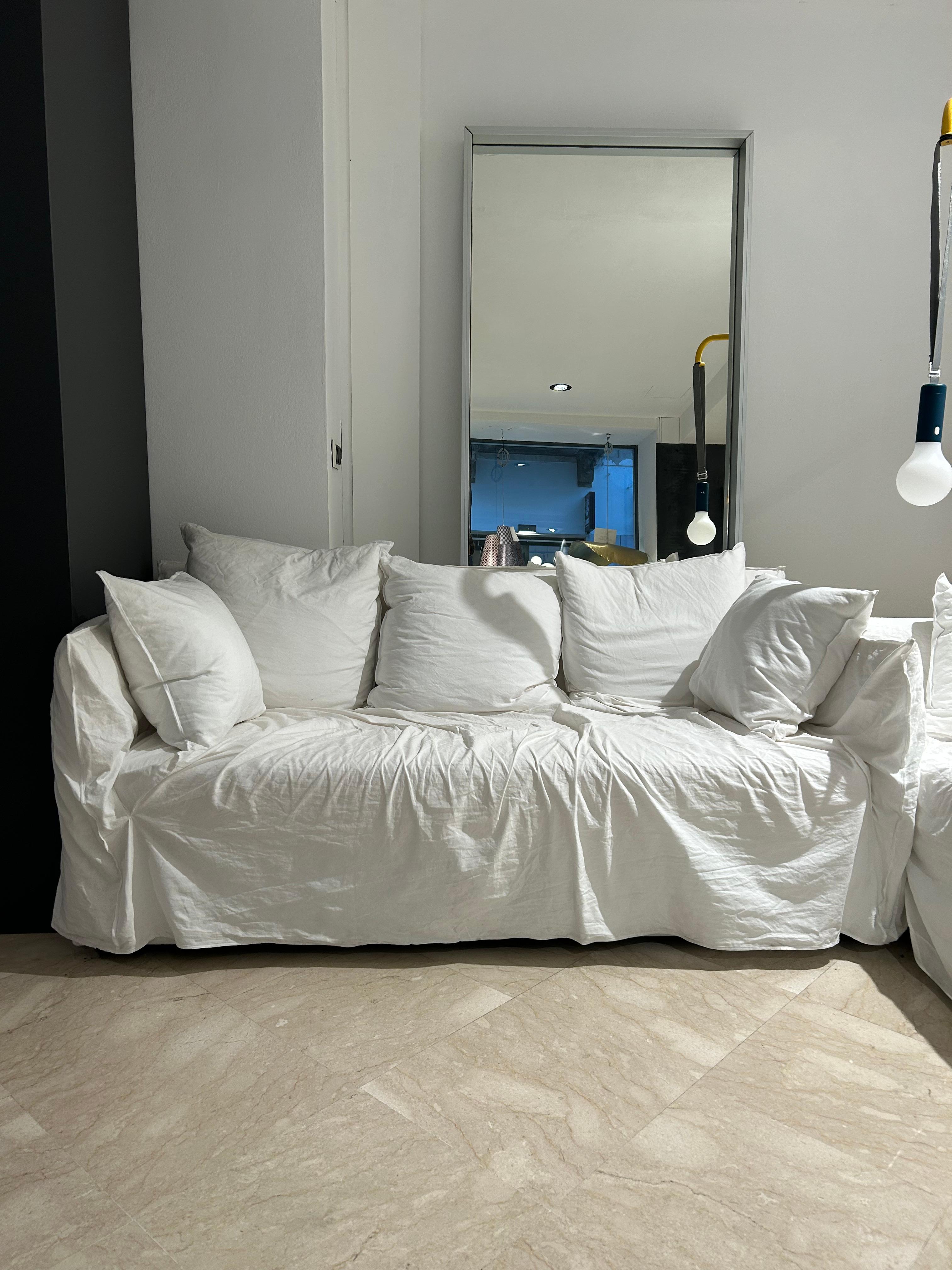 The Ghost 10 sofa by Gervasoni, designed by Paola Navone, is an exercise in refined simplicity and textile innovation. Built around a light, essential frame padded with high-quality polyurethane foam, it holds generously soft, loose cushions filled