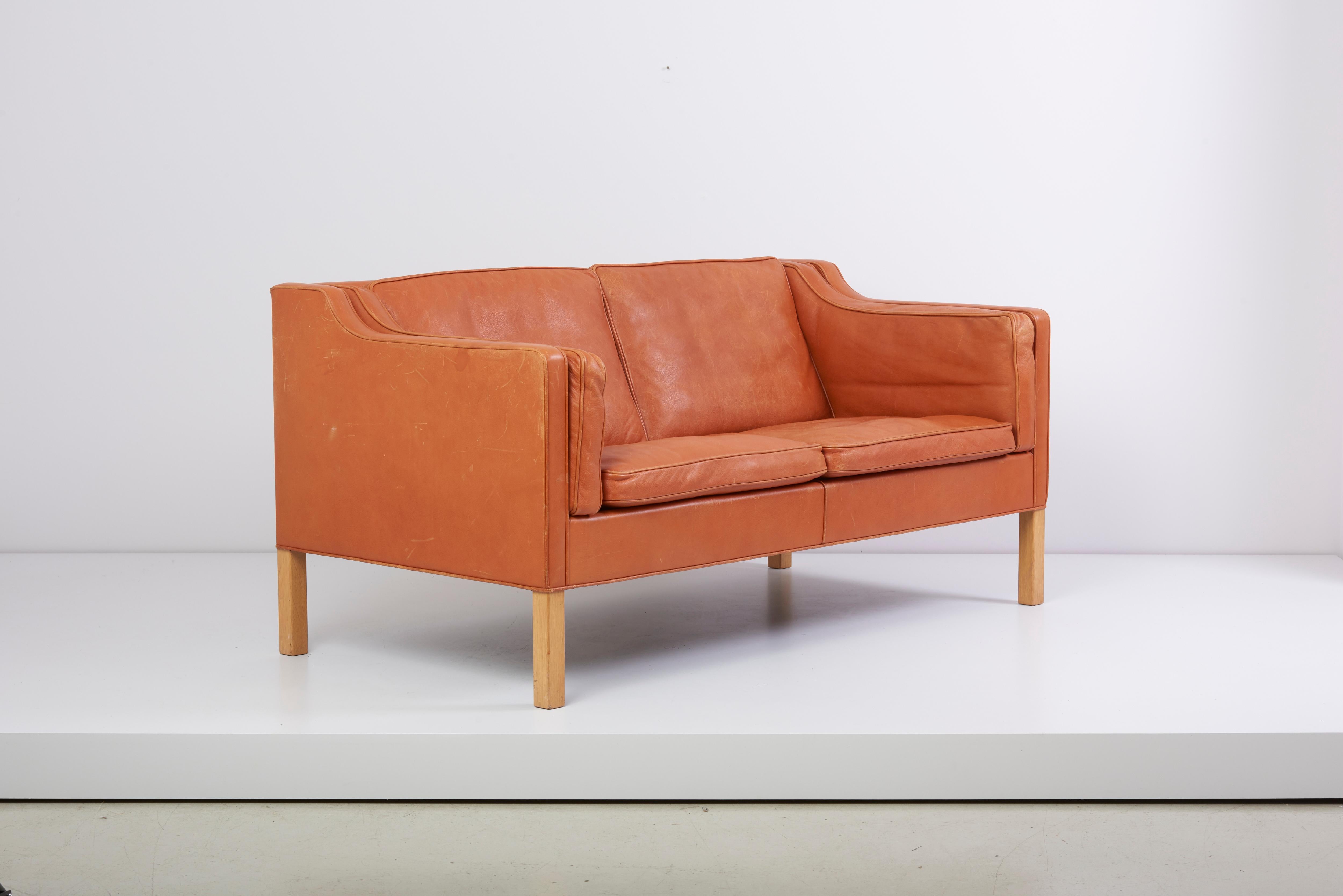 Fantastic early example of the Classic two-seat sofa designed by Børge Mogensen for Fredericia, Denmark, model 2212. This example in wonderful and super rare thick cognac leather with perfect vintage patina.