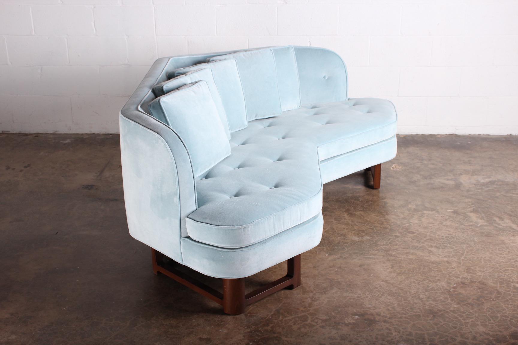 Dunbar angle sofa 6329 designed by Edward Wormley. Fully restored with powder blue velvet and mahogany base.
