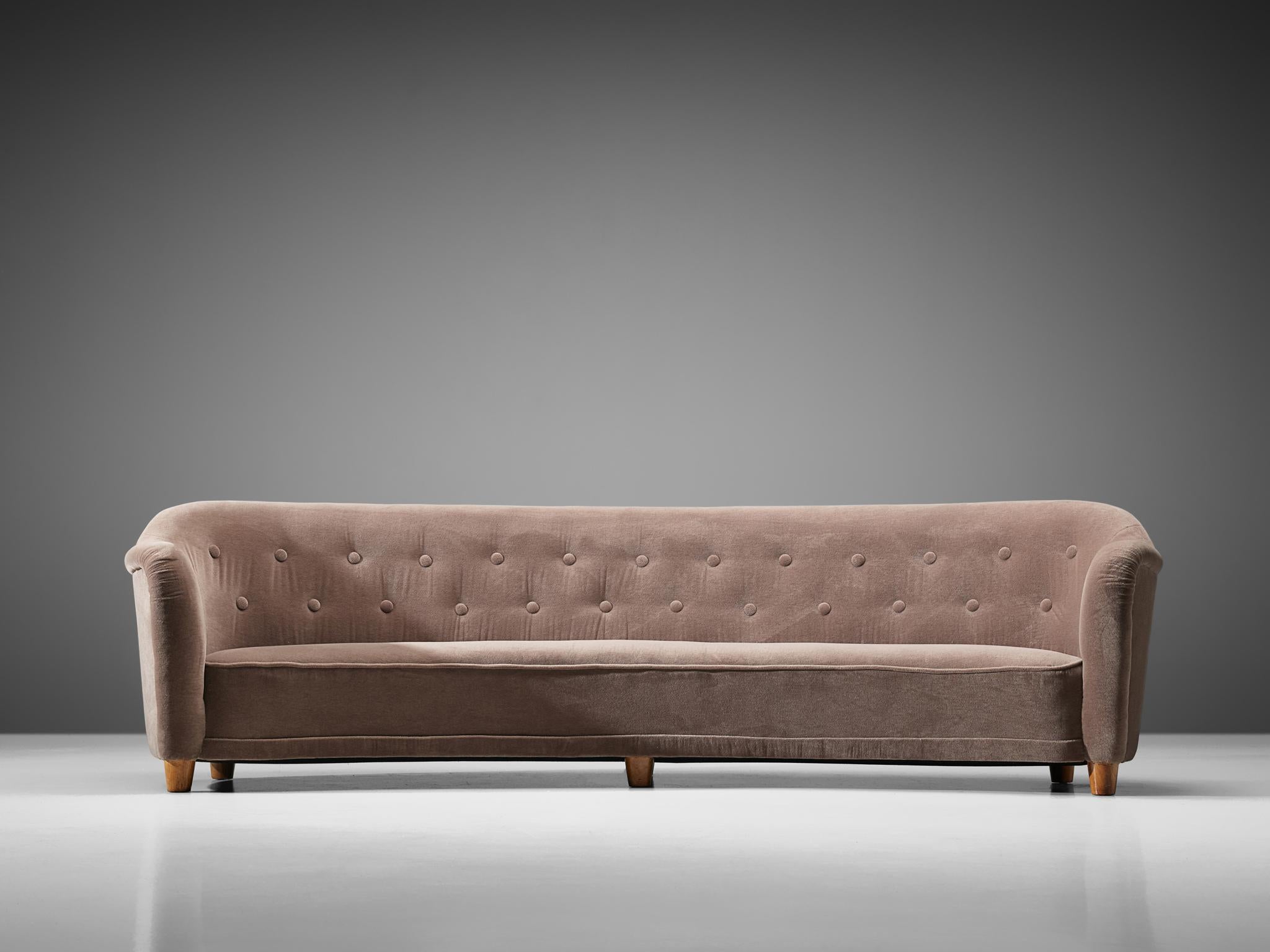 Large curved sofa, possibly by Greta Magnusson-Grossman for Studio, wood and fabric,

Sweden, circa 1938.

This rare sofa, upholstered in a mauve velvet fabric was produced circa 1938. The design is attributed to designer Greta Magnusson-Grossman