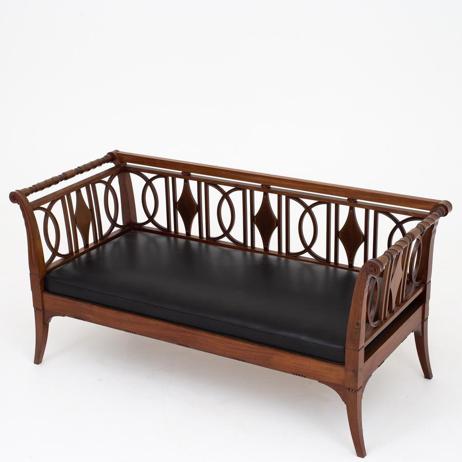 Sofa-bench in mahogany with inlays in light wood and seat in black leather. Maker Johan Rohde.