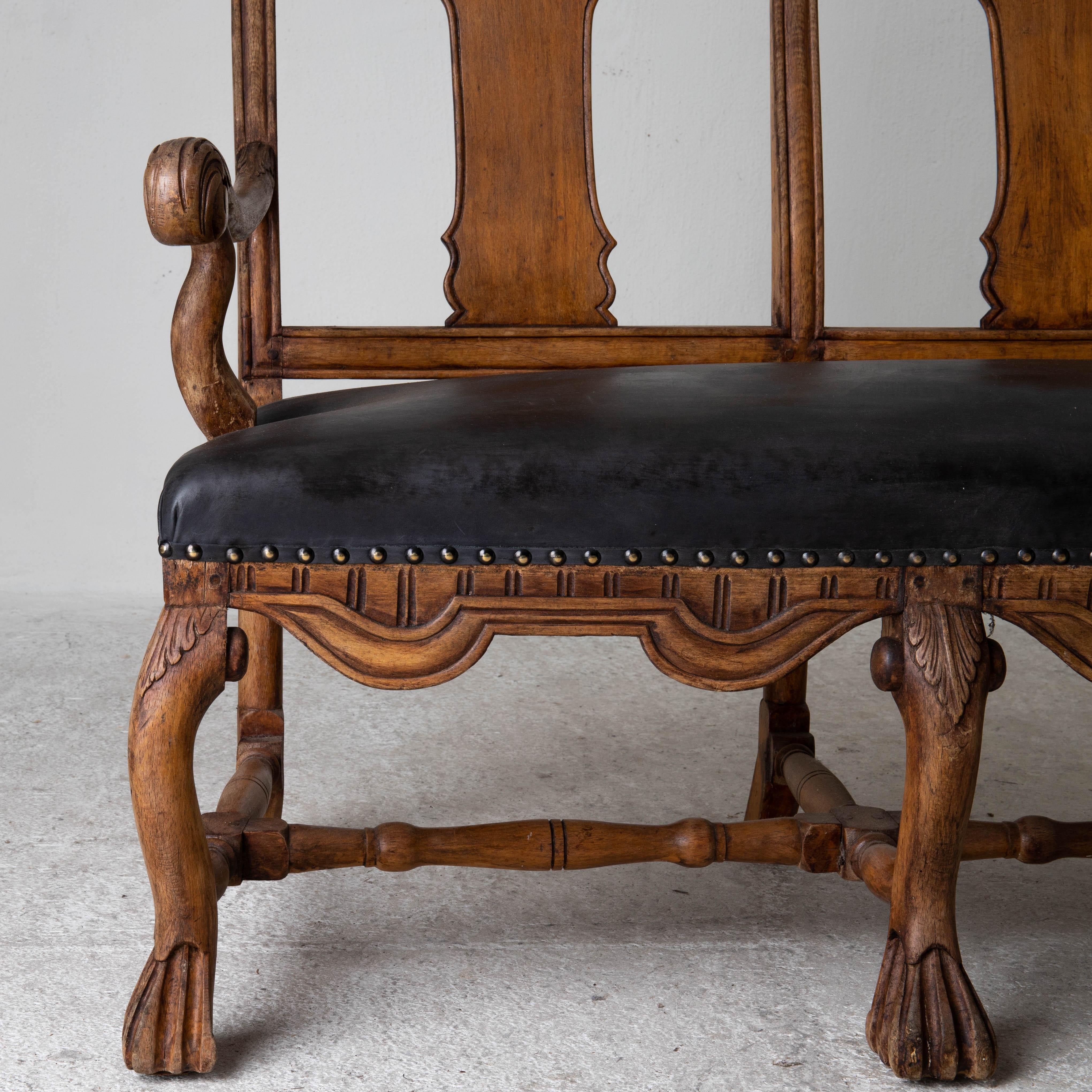 Sofa bench Swedish Baroque Period 1650-1750 brown black, Sweden. A sofa bench made during the Baroque Period 1650-1750 in Sweden / Northern Europe. The seat has been reupholstered in a waxed vintage leather. Finished with brass nail heads.

  