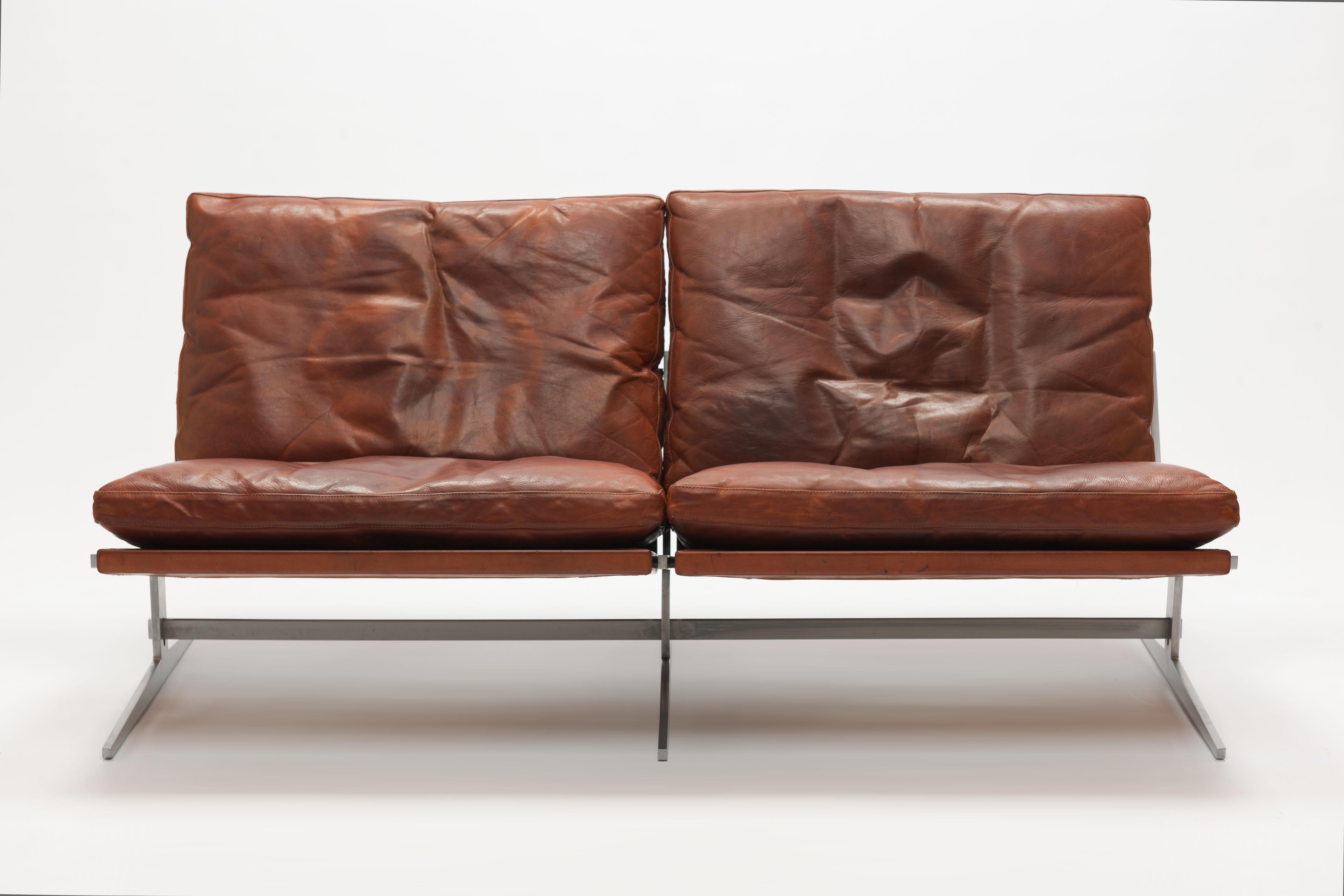 Beautiful cognac leather sofa model BO-562 by Danish designers Jørgen Kastholm & Preben Fabricius, executed mid 1960s by BO-Ex Denmark. 
A mayor comfortable design, due to the down filled cushions, with great sharp lines and a striking base. Very