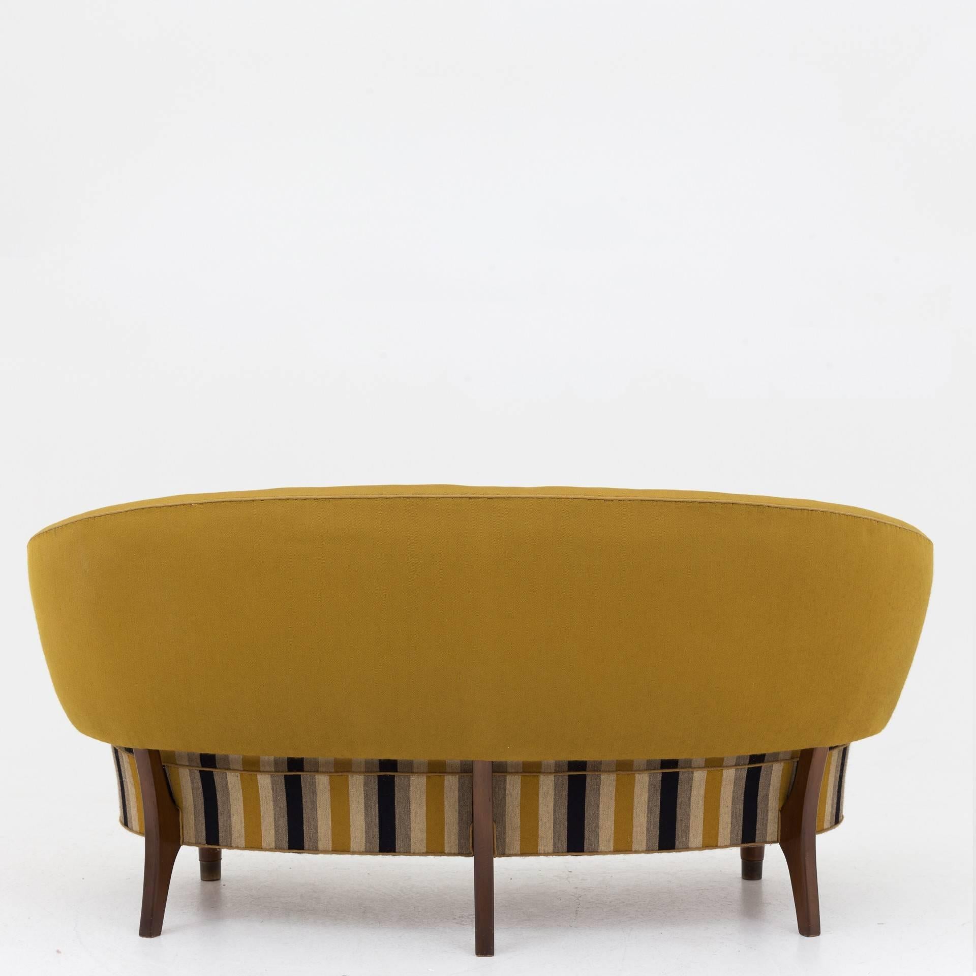 Sofa with floating back in yellow and brown fabric. Leg in stained beech and brass feet. Designed in 1953. Maker Sattrups Polstermøbelfabrik.