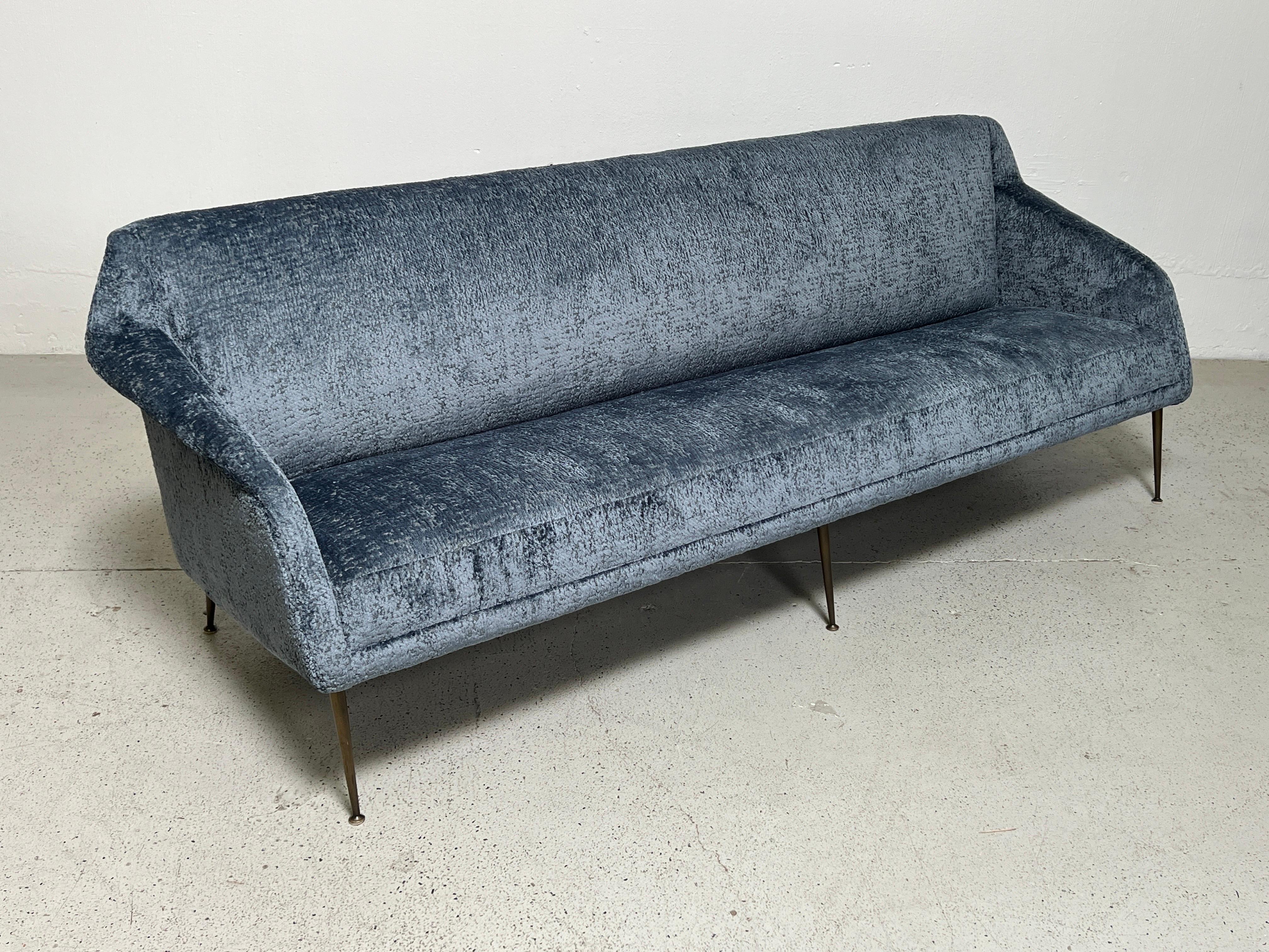 A rare sofa designed by Carlo de Carli for Singer and Sons. Fully restored and upholstered in Holly Hunt / Plushy / Teal fabric. Matching chair available separately. 