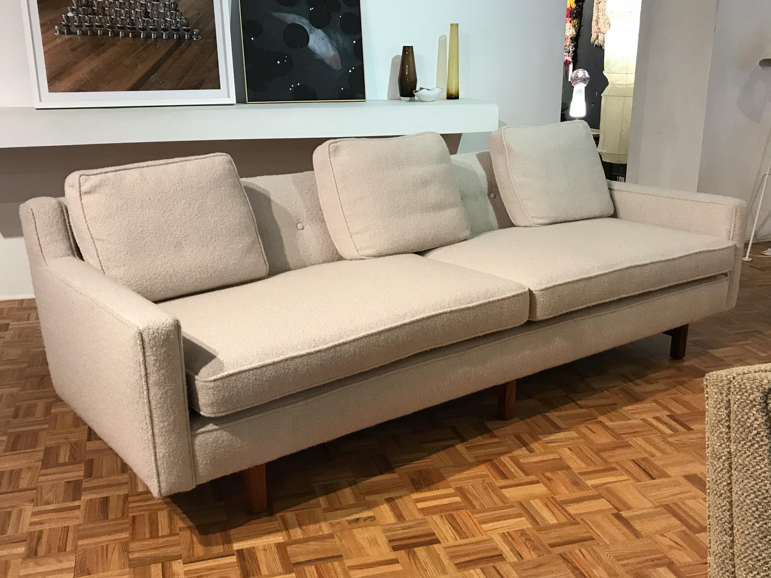 Beautiful midcentury sofa designed by Edward Wormley for Dunbar. Excellent vintage condition, frame is newly upholstered in period-correct fabric and rests on solid walnut legs. Includes a set of three throw cushions.