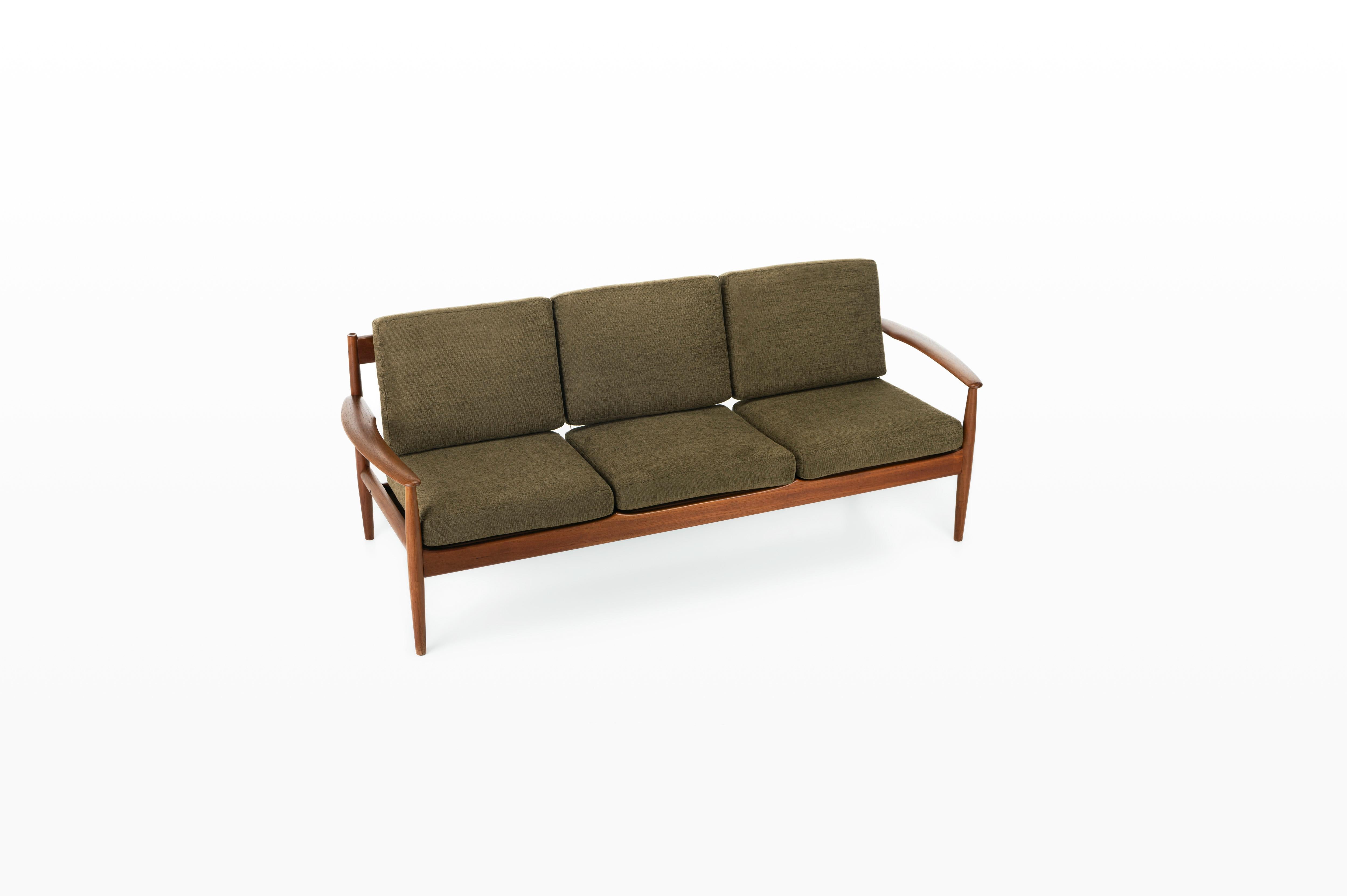 Sofa in teak designed by Grete Jalk for France & Daverkosen in 1962. This sofa is reupholstered with a khaki green fabric and is marked by the producer.