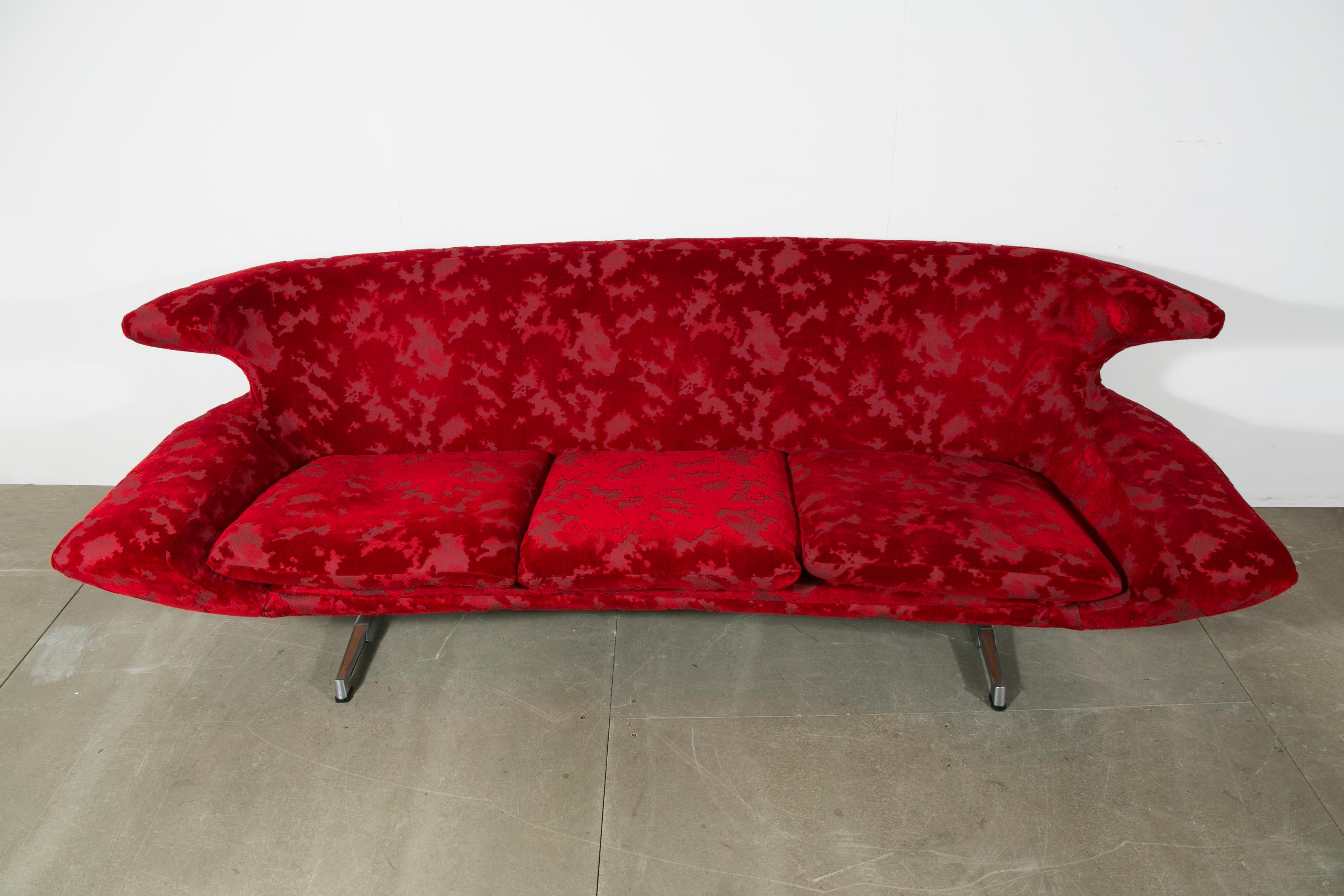 This sofa was created by designer Hans Erik Johanson in Sweden in the 1960s. 
Red fabric.