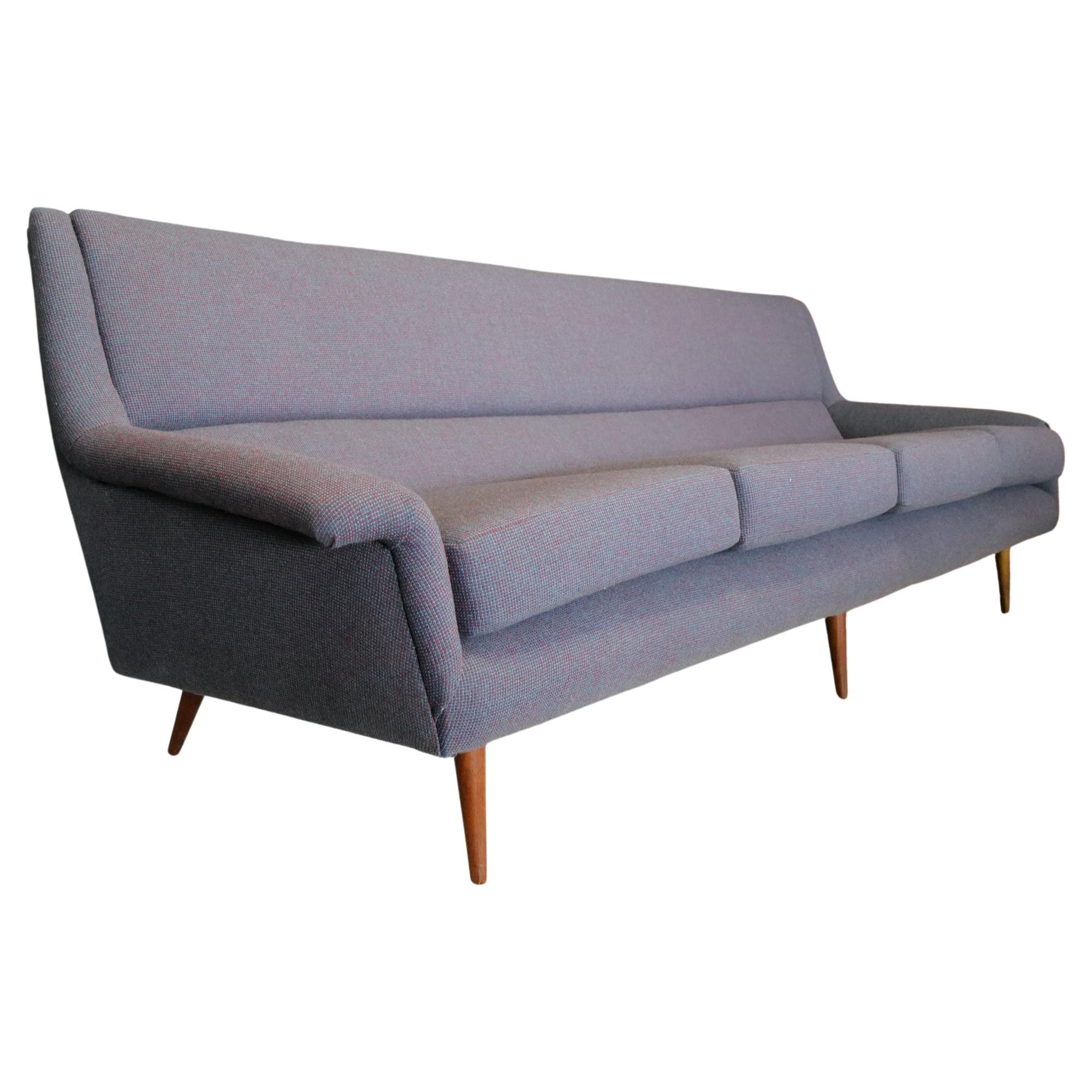 Milo Baughman's tapered leg sofa, adorned with a fresh Herman Miller, Alexander Girard fabric and new foam, exudes timeless sophistication. The sleek, tapered legs provide a modern touch to the classic silhouette. The upholstery, featuring Alexander