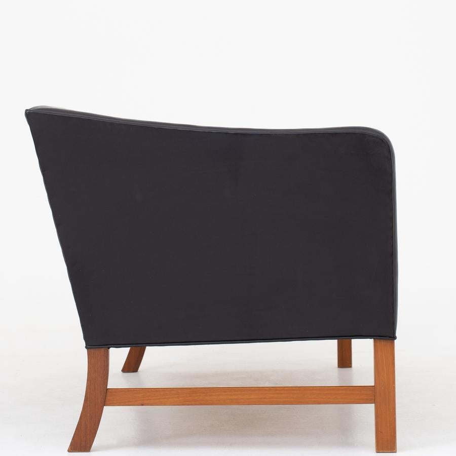 OW 602 - 2-seat sofa in original, patinated black leather on a frame of mahogany. Maker A. J. Iversen.