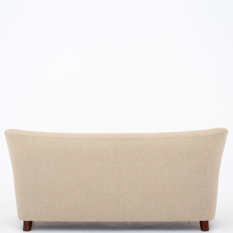 Sofa in beige Hallingdal wool with legs in stained beech. Maker Thorald Madsen.