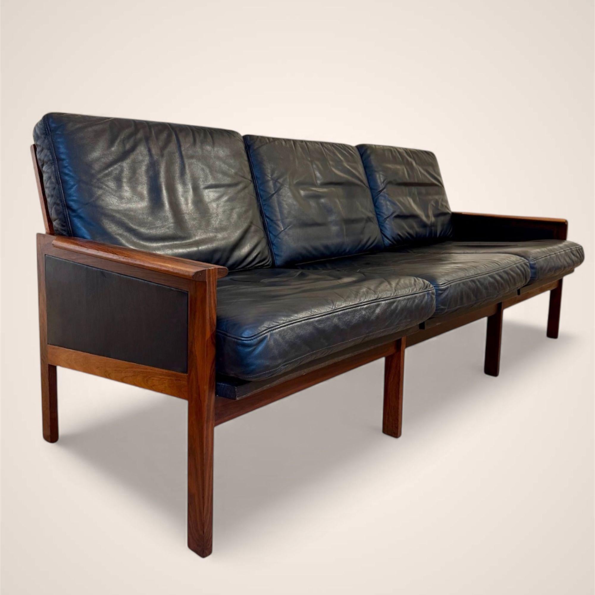 Très beau et assez rare sofa « Capella » 3 places en palissandre et cuir d’origine conçu par le designer danois Illum Wikkelsø. Il se distingue par sa structure en palissandre massif de haute qualité, par ses proportions parfaites et un souci du