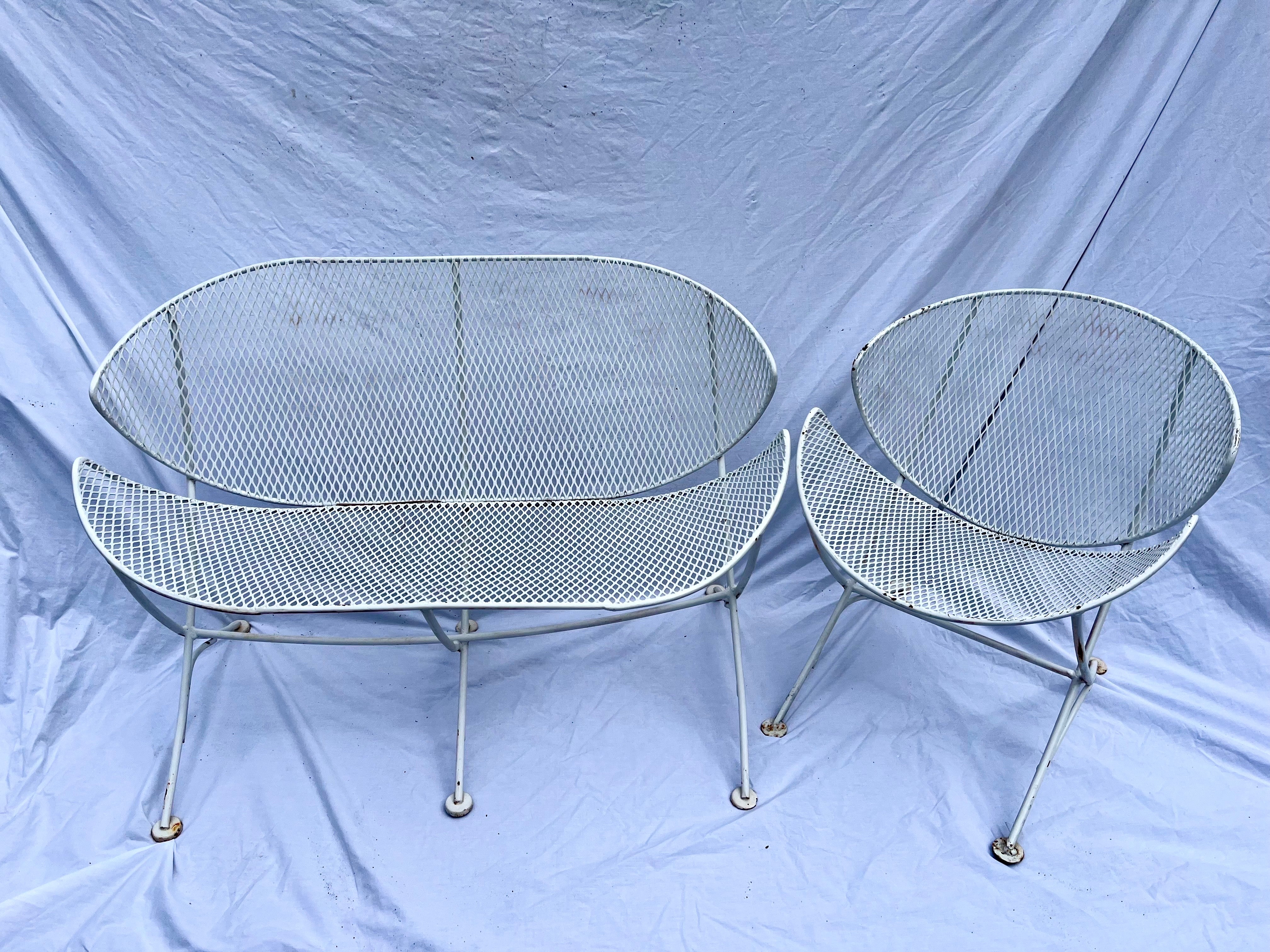 A beautiful sofa and chair (being sold as a set of two pieces) designed by Maurizio Tempestini for Salterini. This is his iconic clamshell design. Featuring a mesh seat and clamshell style hoop support for both the sofa and chair. The set of two