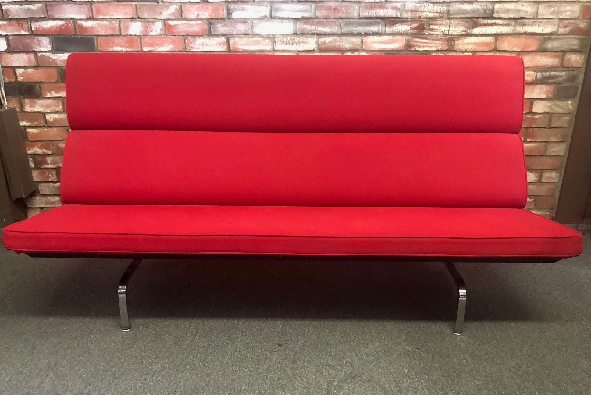 A very nice sofa compact in red fabric by Charles & Ray Eames for Herman Miller, circa 2001. The sofa sits on an airy pedestal of chromed-steel legs and has plush foam cushions which are supported by resilient webbing that provides firm but flexible