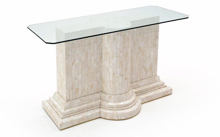 Travertine and Glass console or sofa table, 1970s. Tessellated travertine base with a clear glass top with angled corners. The base could easily take a larger glass top if one so desired. Very good condition with a small repair to the rear right