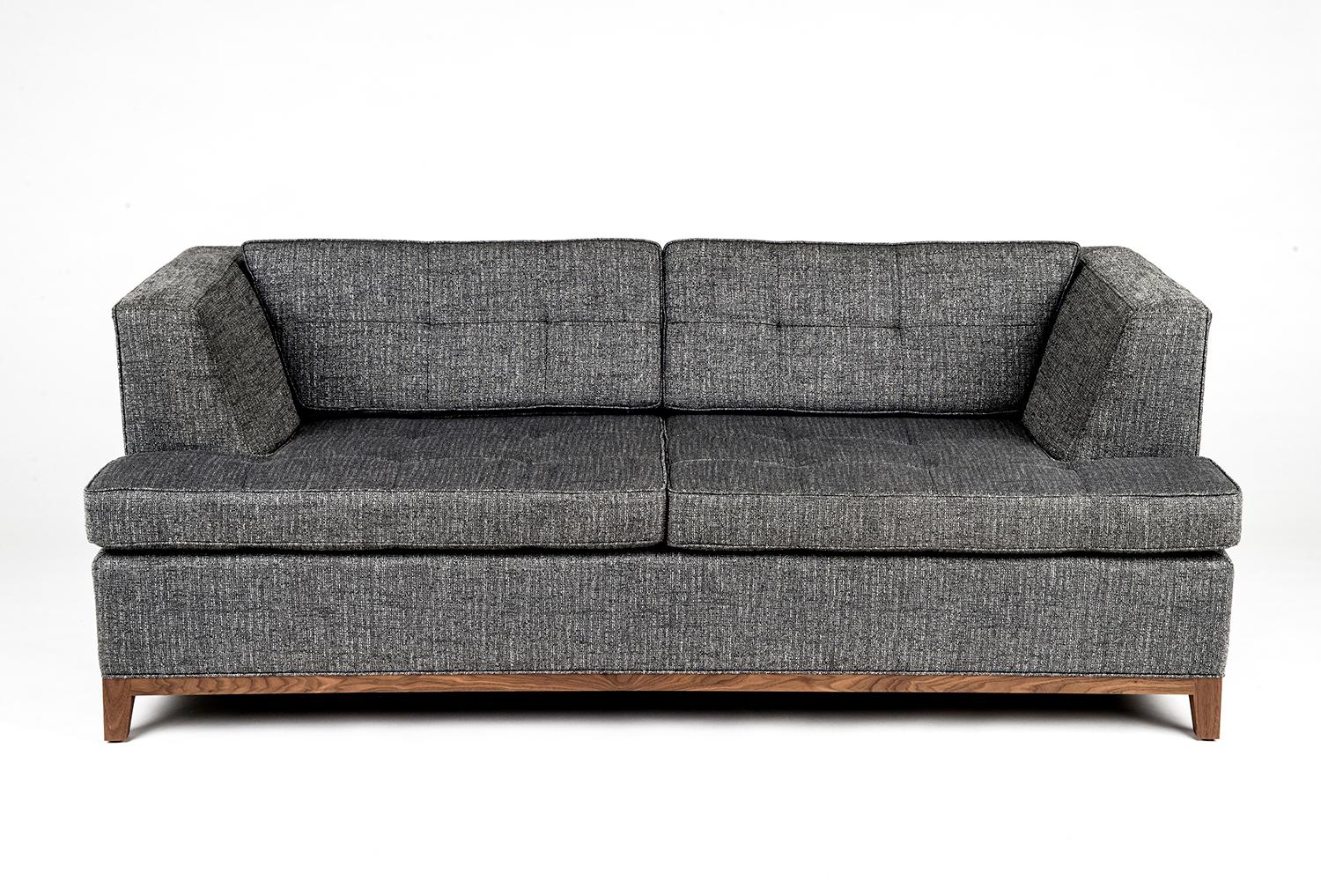 Deep-seated sofa available in the upholstery of your choice. This couch has solid maple frame construction with tenons to prevent squeaking. Hand coiled individual springs, and the finest upholstery methods available. Shown with Rift Ottoman.