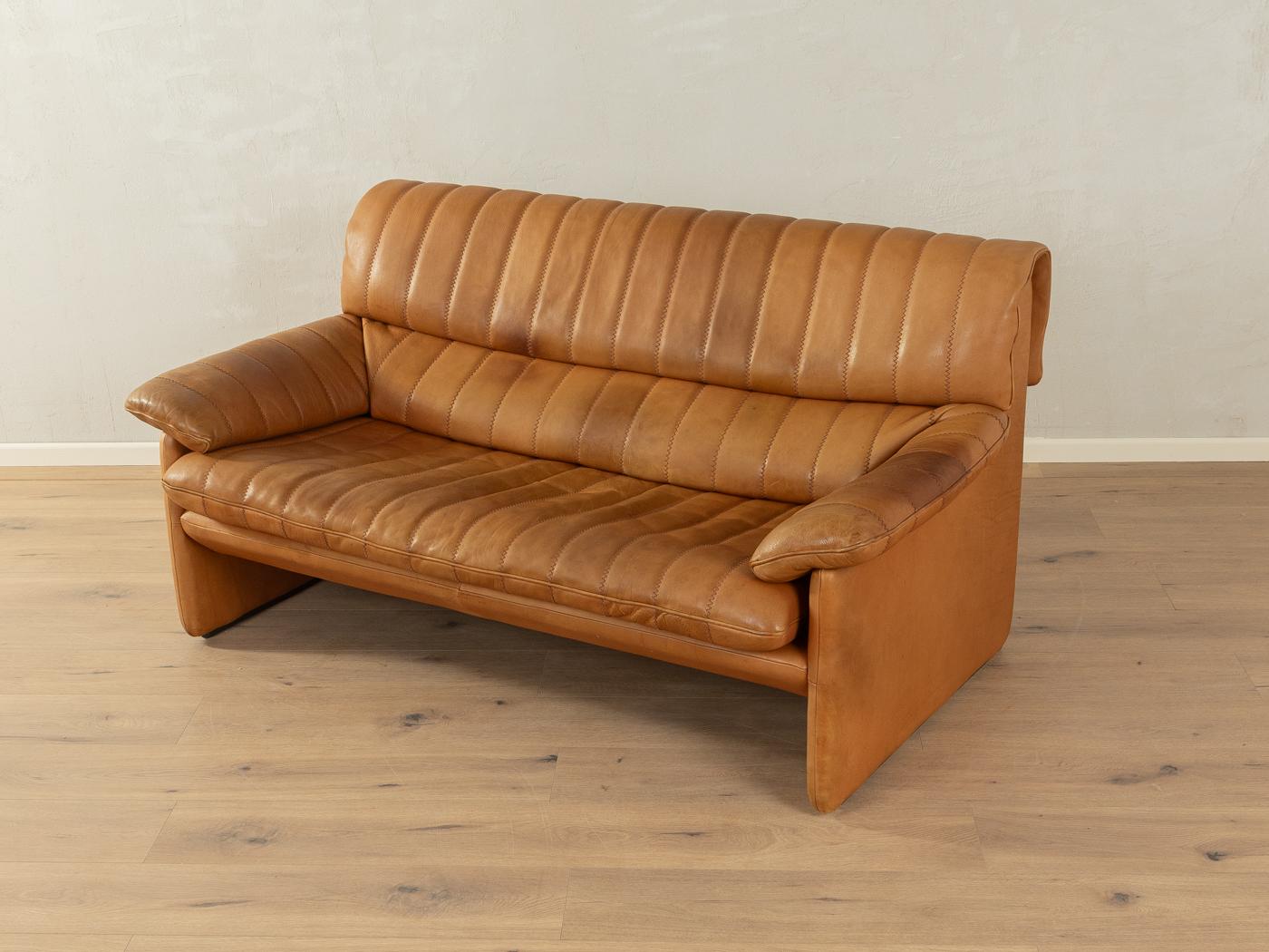 Classic sofa from the 1970s. Model DS-86 by de Sede with the striking original cover made of cognac-coloured leather with a beautiful patina and coarse stitching.

Quality Features:
    very good workmanship
    high-quality materials
    Made in