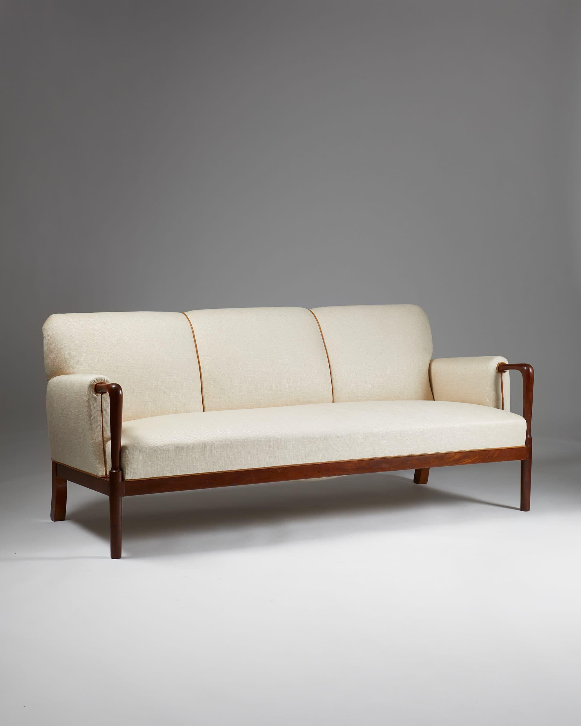 Sofa designed by N.D. Hansen and Flemming Johansen for cabinetmaker Ove Lander
Denmark, 1930s

Cuban mahogany frame with linen-blend upholstery and leather piping.

From a private Danish collection. 

This very rare three-seater sofa was first