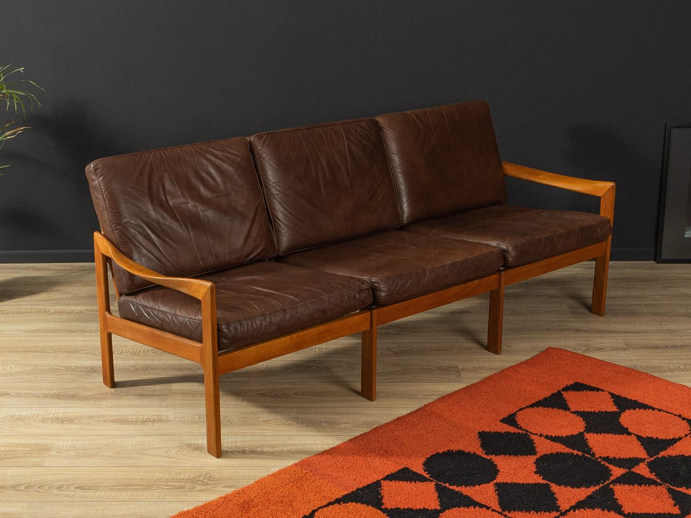 Classic sofa from the 1960s. High-quality frame made of solid teak with the high-quality original leather cover in brown.

Quality Features:
- accomplished design: perfect proportions and visible attention to detail
- high-quality workmanship
