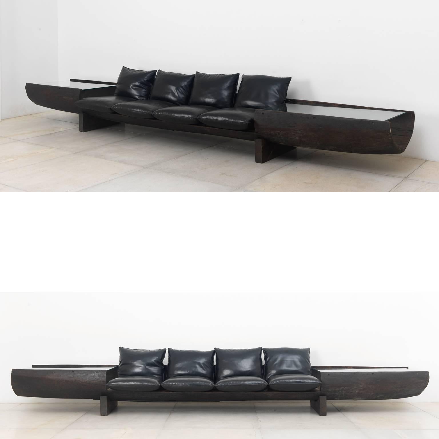 Huge sofa in Brazilian hardwood and black faux leather by Jose Zanine Caldas, 1973
Provenance: from a Zanines' house project in Joatinga neighborhood, Rio de Janeiro.

Zanine is one of the few designers who produced furniture in several schools