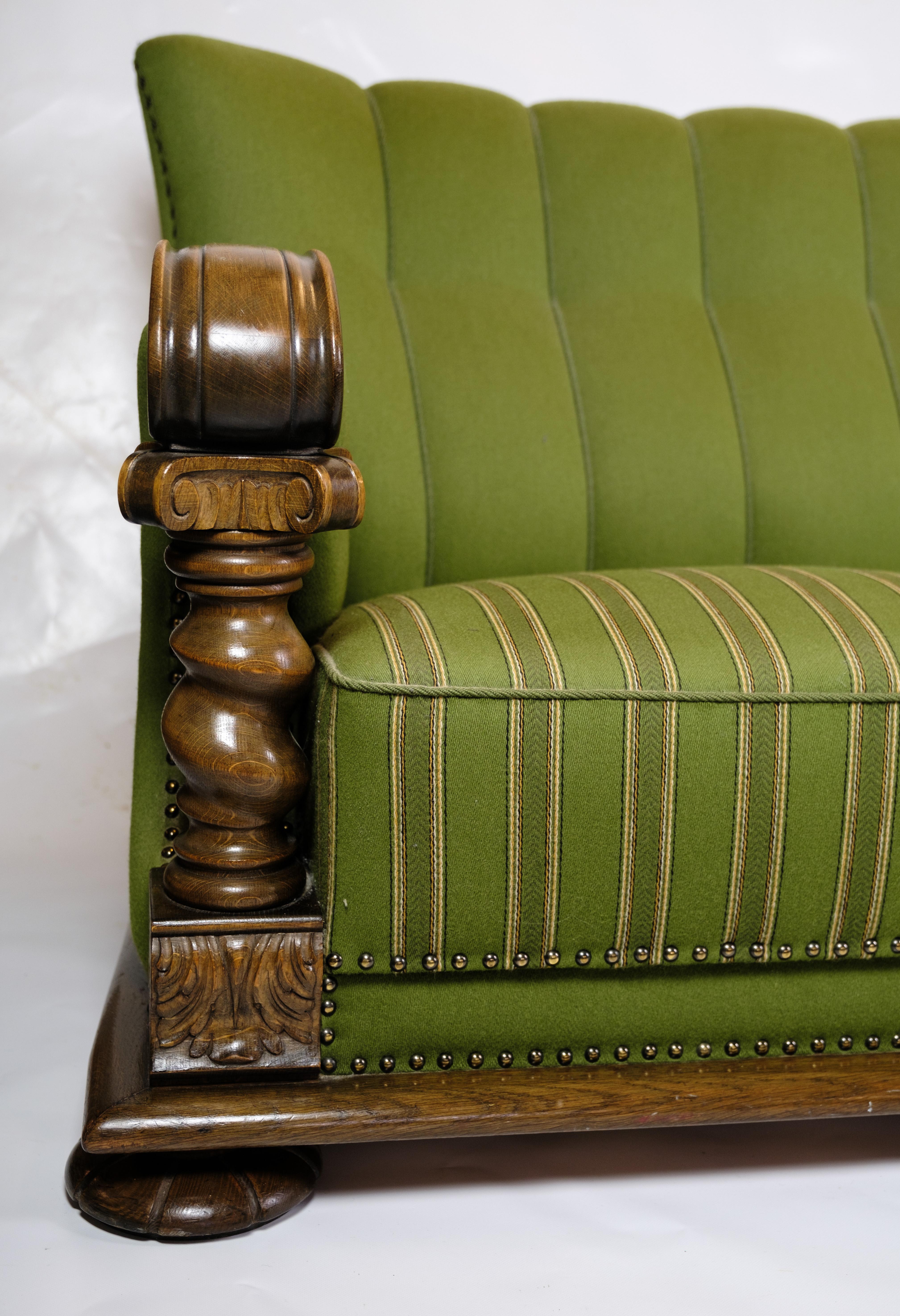 Renaissance Sofa in Green fabric with Wood Carvings from 1920s.
