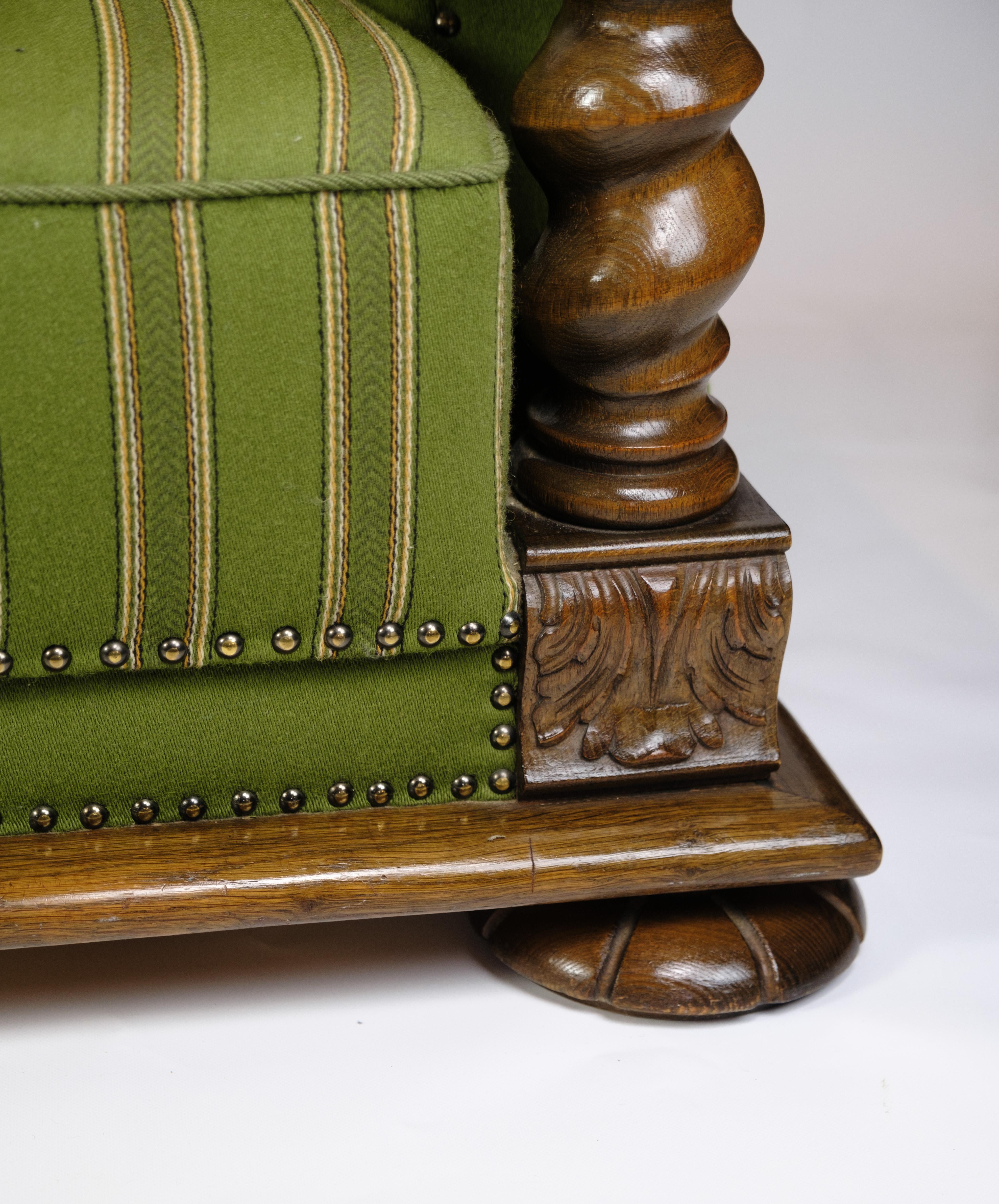 Danish Sofa in Green fabric with Wood Carvings from 1920s.