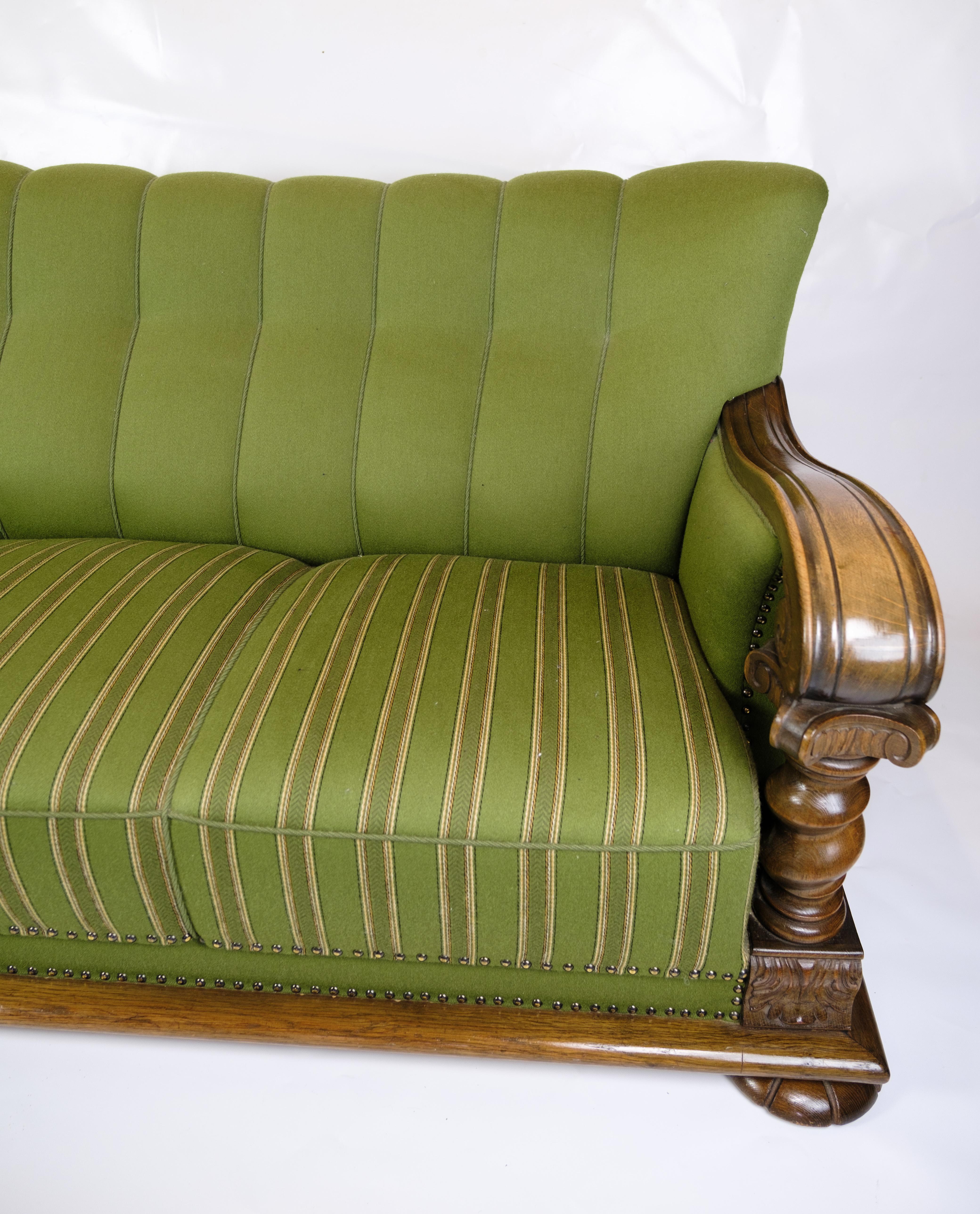Early 20th Century Sofa in Green fabric with Wood Carvings from 1920s.