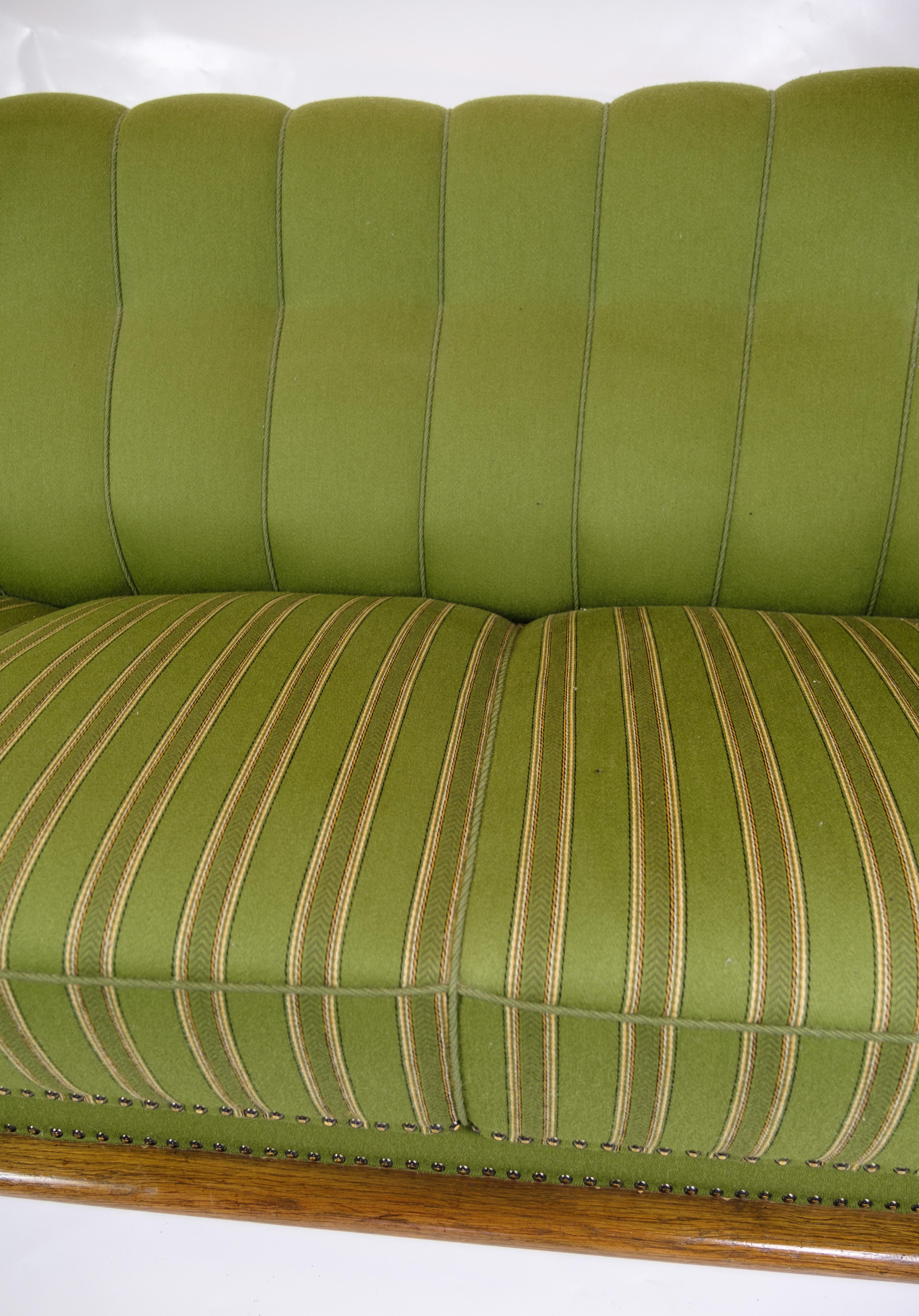 Fabric Sofa in Green fabric with Wood Carvings from 1920s.