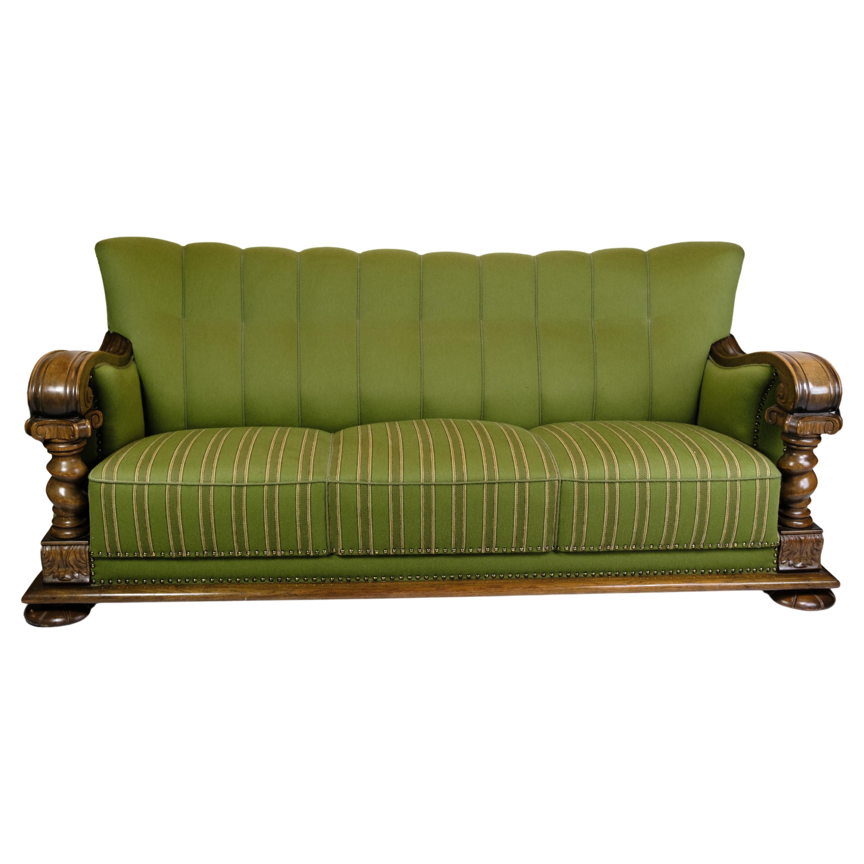 Sofa in Green fabric with Wood Carvings from 1920s.