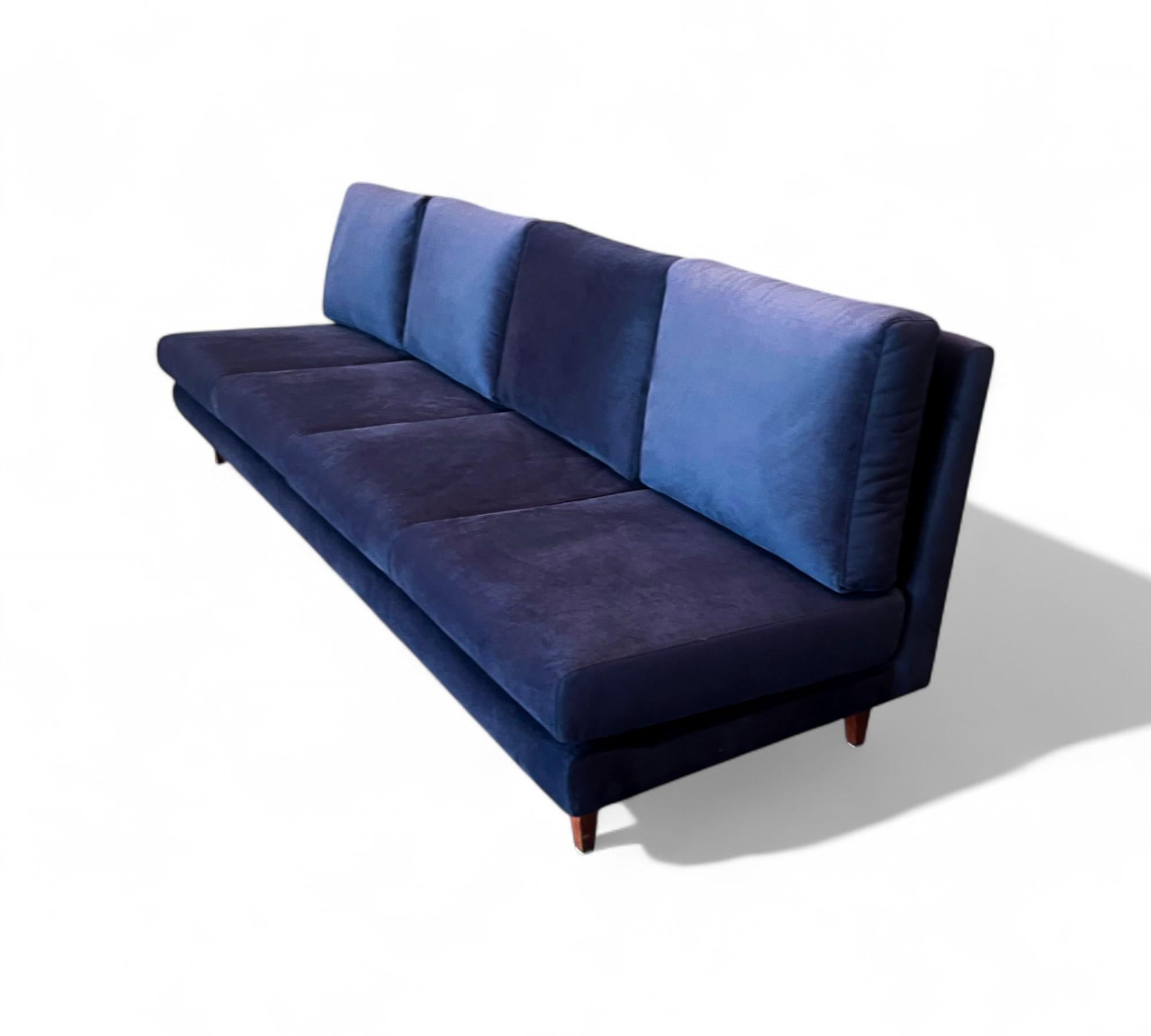 This one-of-a-kind four seat sofa with no arms was designed by Joaquim Tenreiro and manufactured by Tenreiro Moveis e Decoraçoes in the late 1950s or early 1960s. The sofa features a solid hardwood structure that has been completely reinforced. The