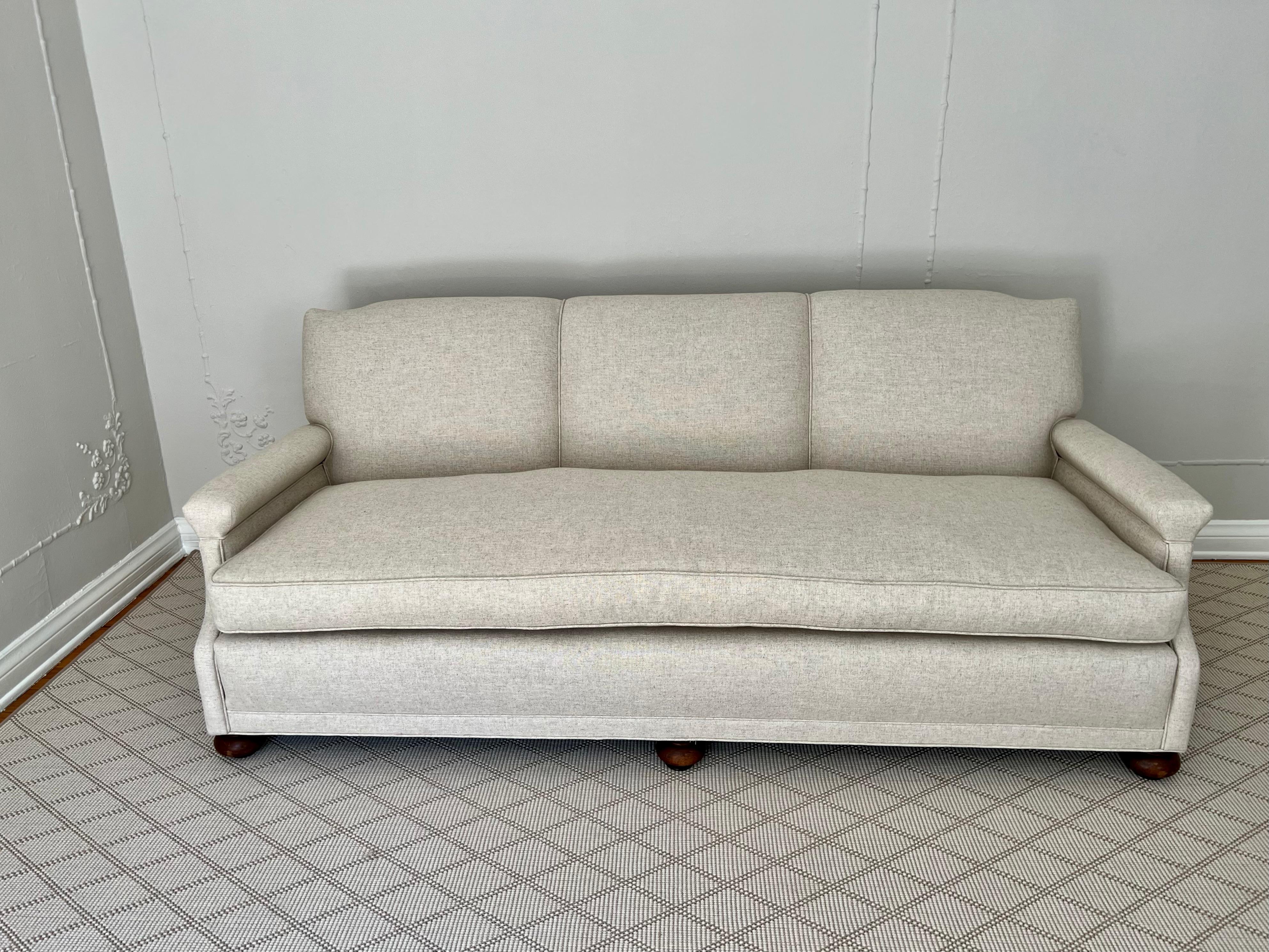 Newly upholstered sofa in neutral linen. This vintage sofa is very well built with hand tied springs - 

The newly upholstered  cushions are down filled and wrapped - a very nice piece with great construction and very durable. We did a neutral linen
