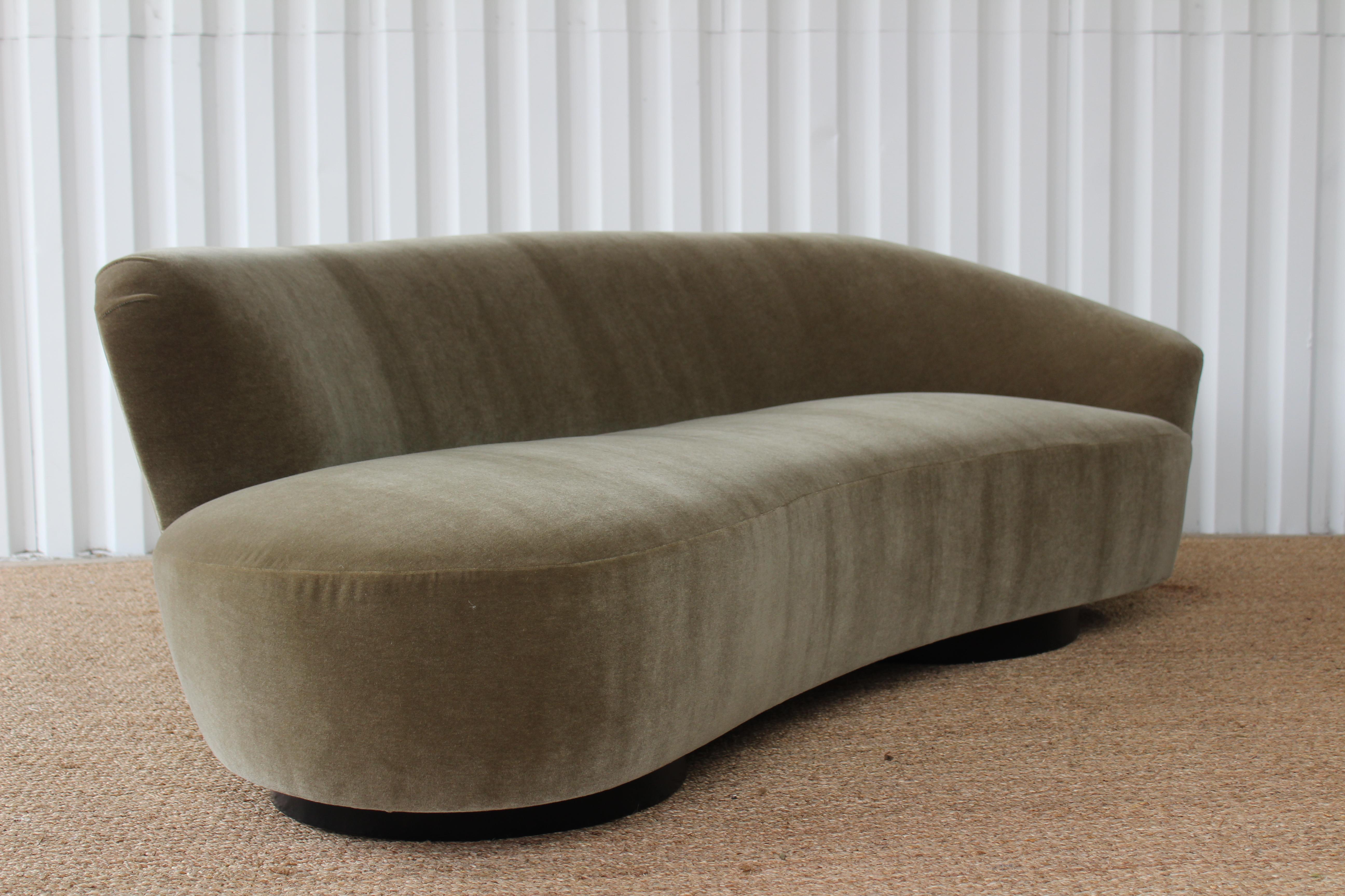Curved sculptural sofa by Vladimir Kagan, 1970s. New olive green Italian mohair upholstery. The base is two circular walnut bases which were refinished satin black.
