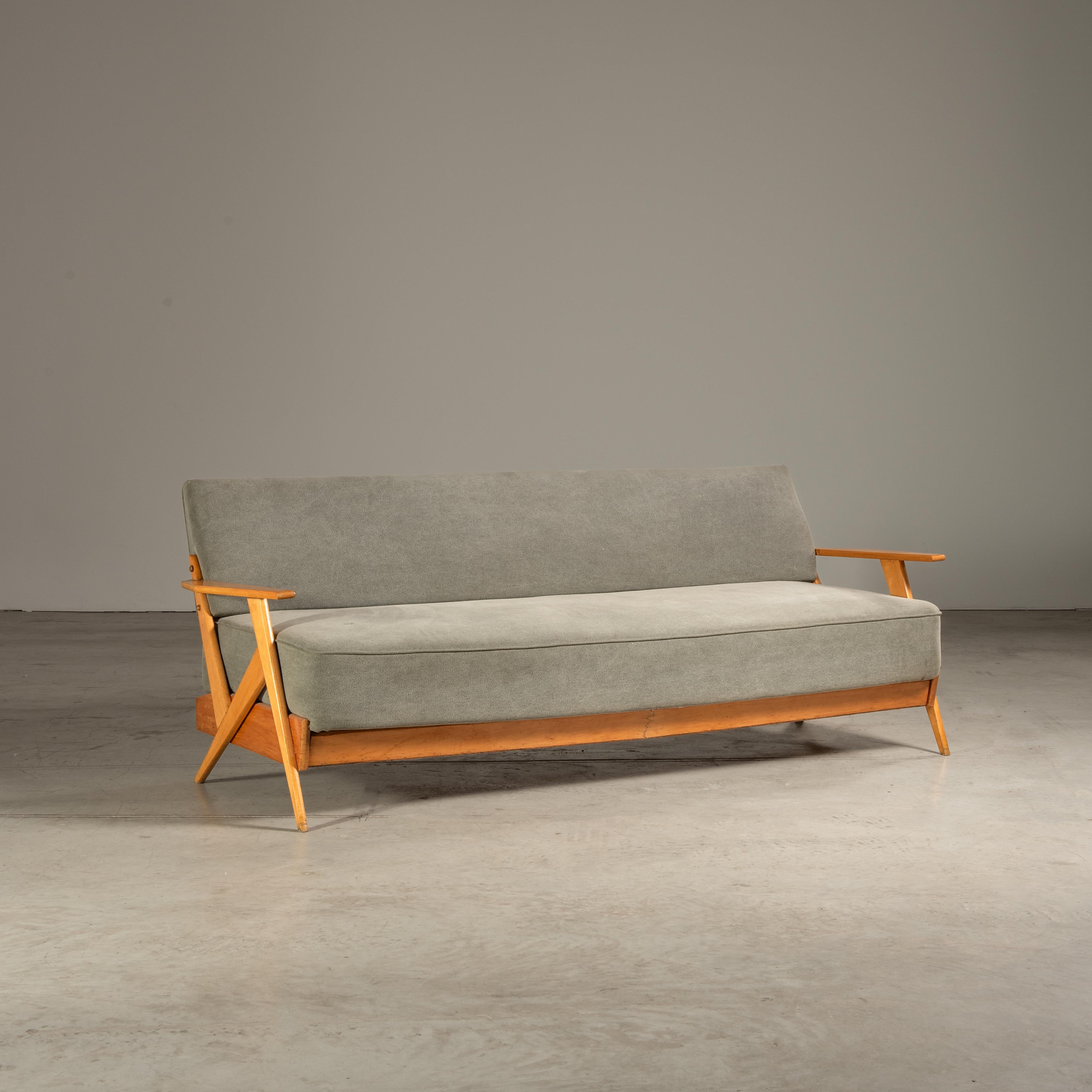 The sofa designed by H. Schnicker for Móveis Artísticos Z is a masterful representation of Brazilian mid-century modern design, seamlessly blending contemporary sensibilities with the era's characteristic warmth and structural clarity. Crafted from