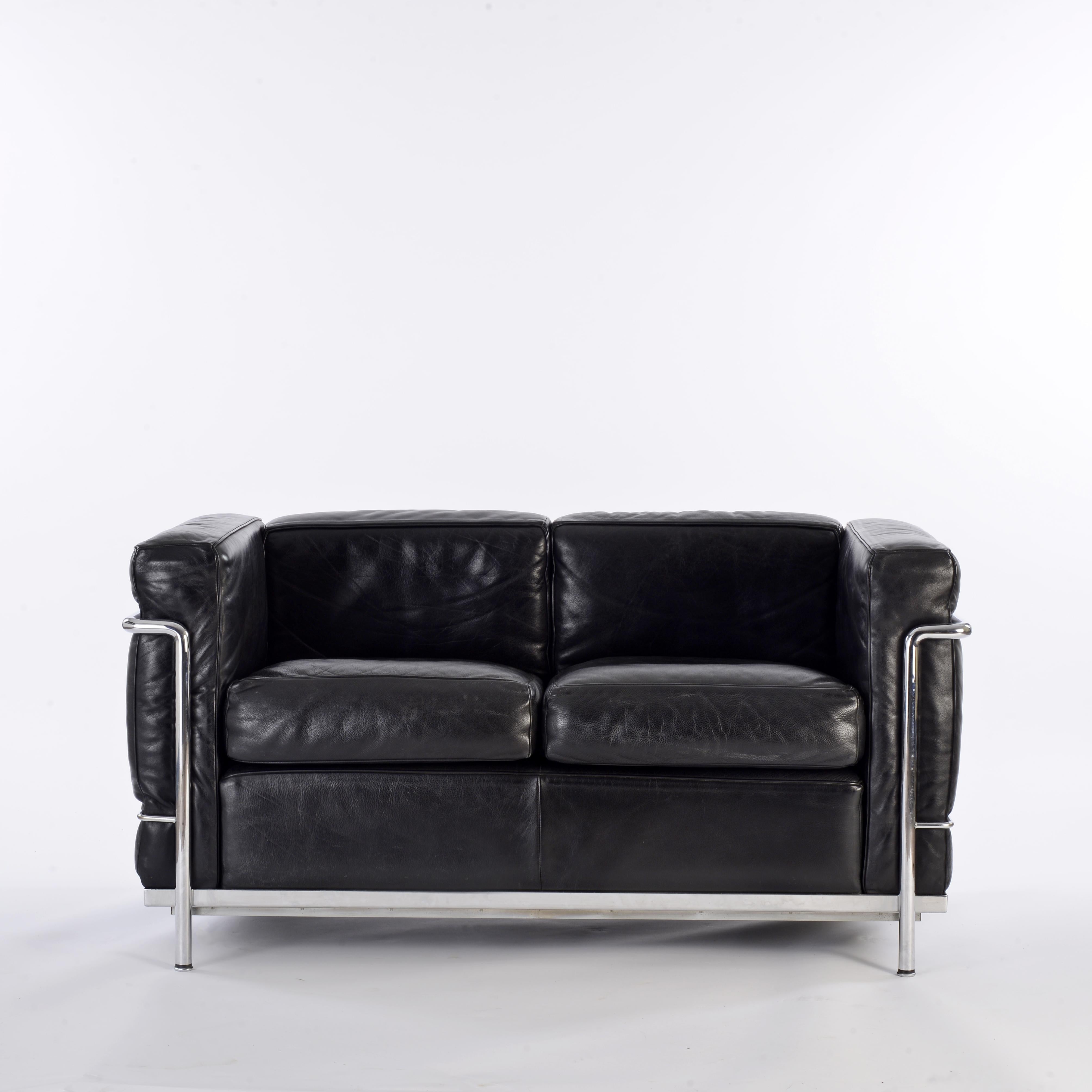 Two seater sofa, model LC2, in black leather, design by Charles-Edouard Jeanneret-Gris known as Le Corbusier, Pierre Jeanneret and Charlotte Perriand in 1929. Adapted by Charlotte Perriand in 1978 for Cassina. Cassina edition stamped, numbered and